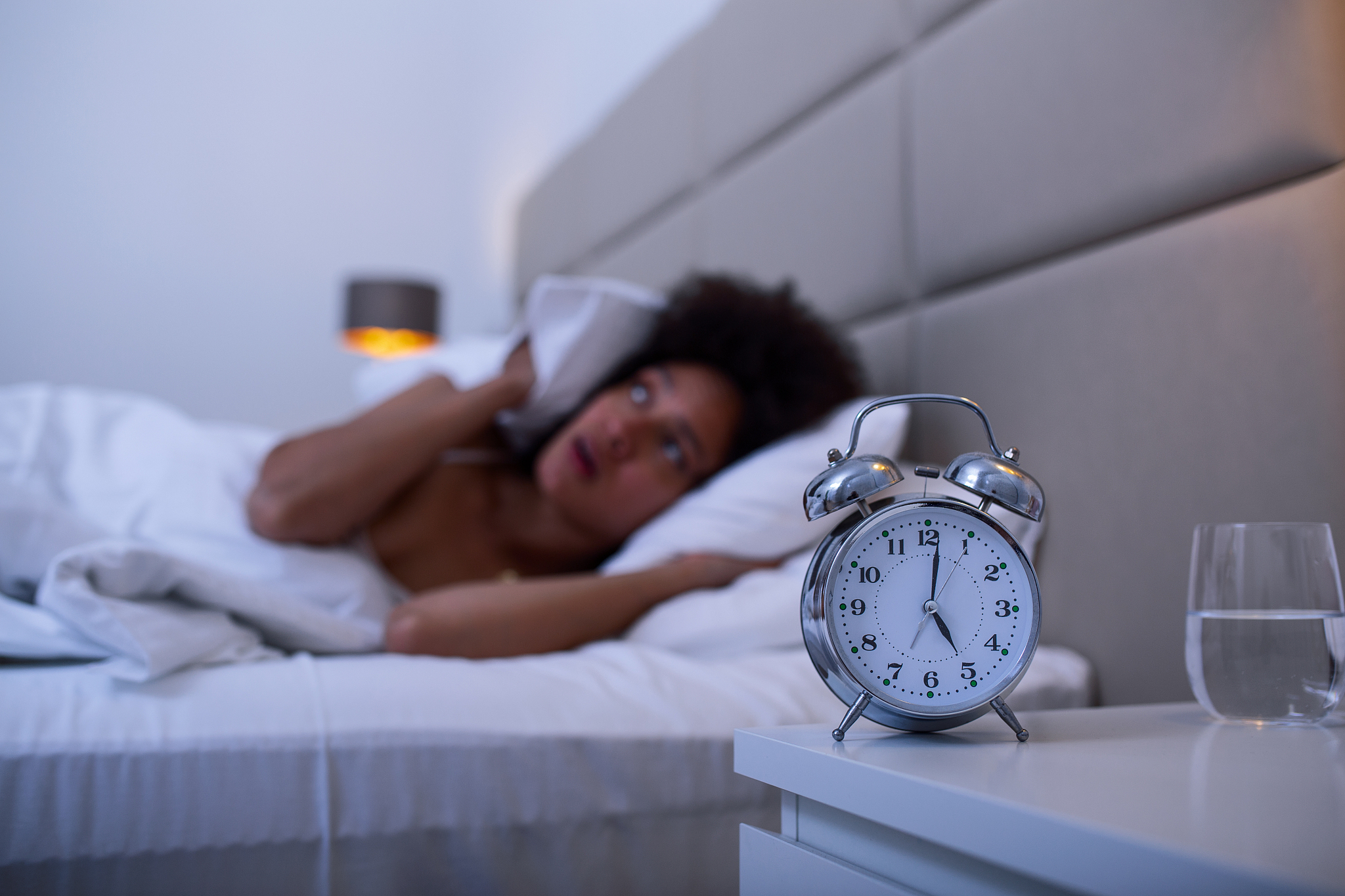 woman lying in bed suffering from insomnia, sleepless and desper