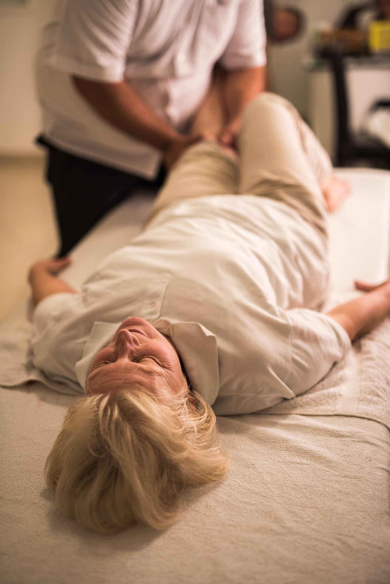 senior woman relaxing on physical therapy treatment.