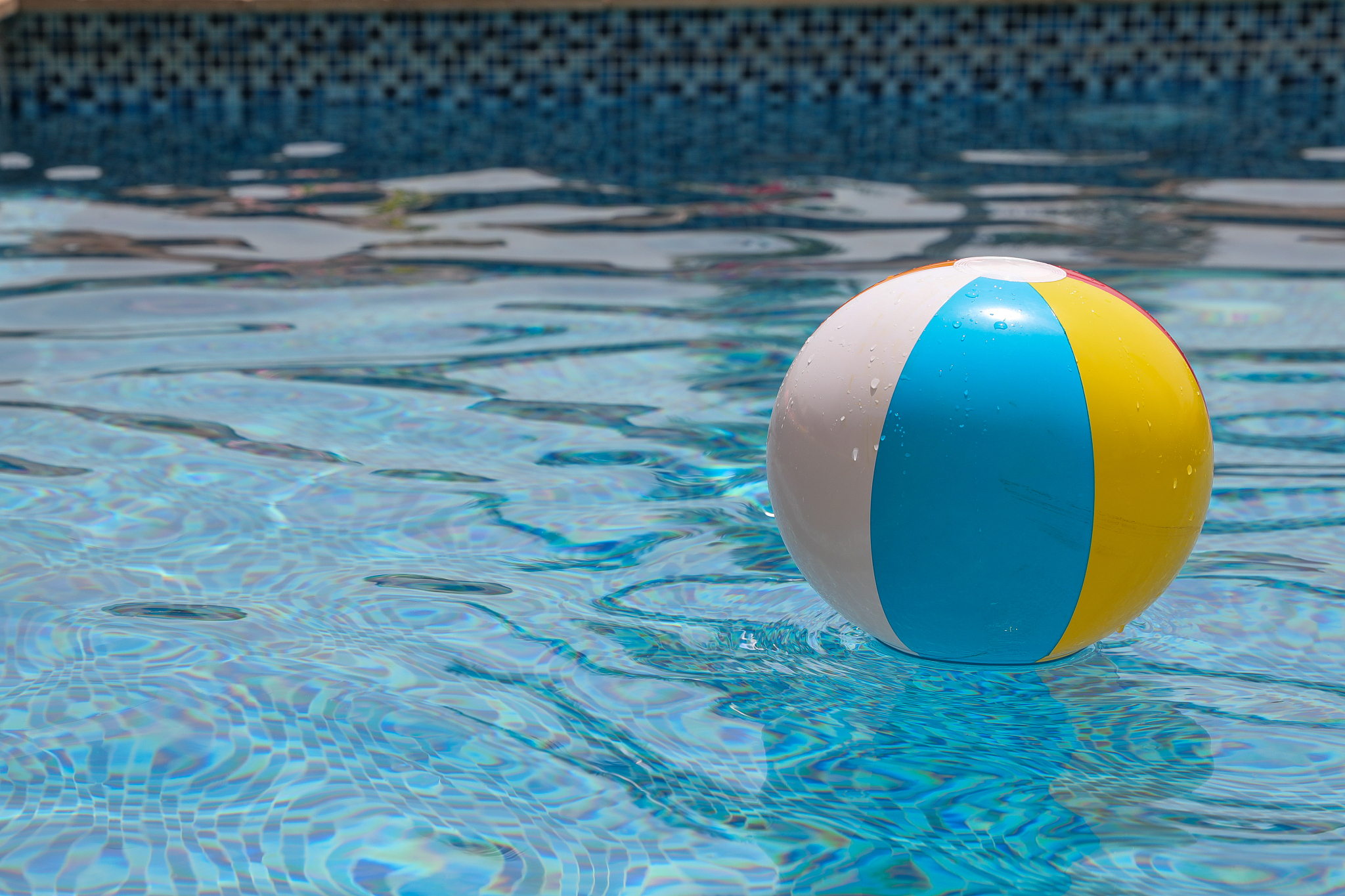 beach ball in pool. colorful inflatable ball floating in swimmin