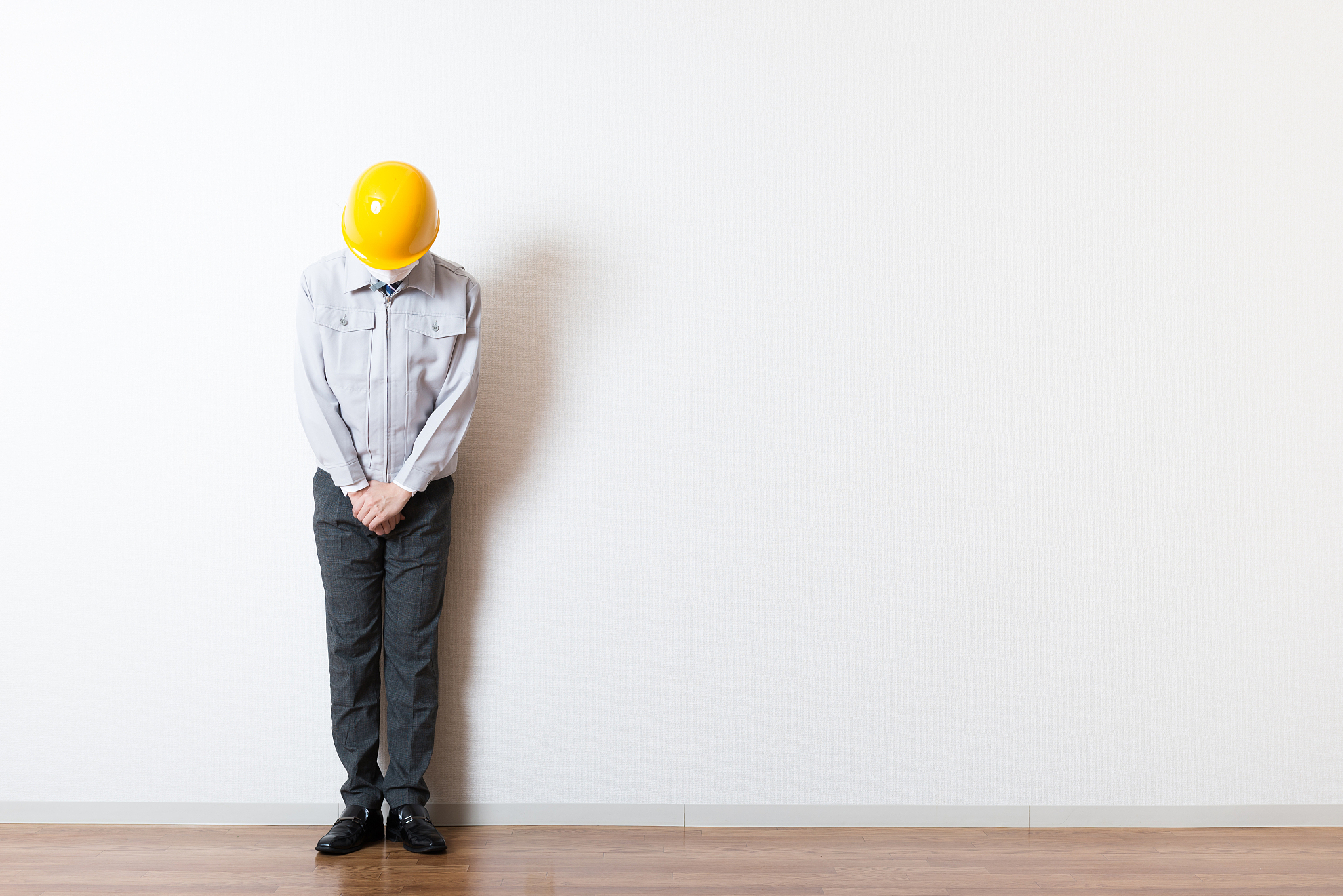 men standing wearing work clothes with a white background