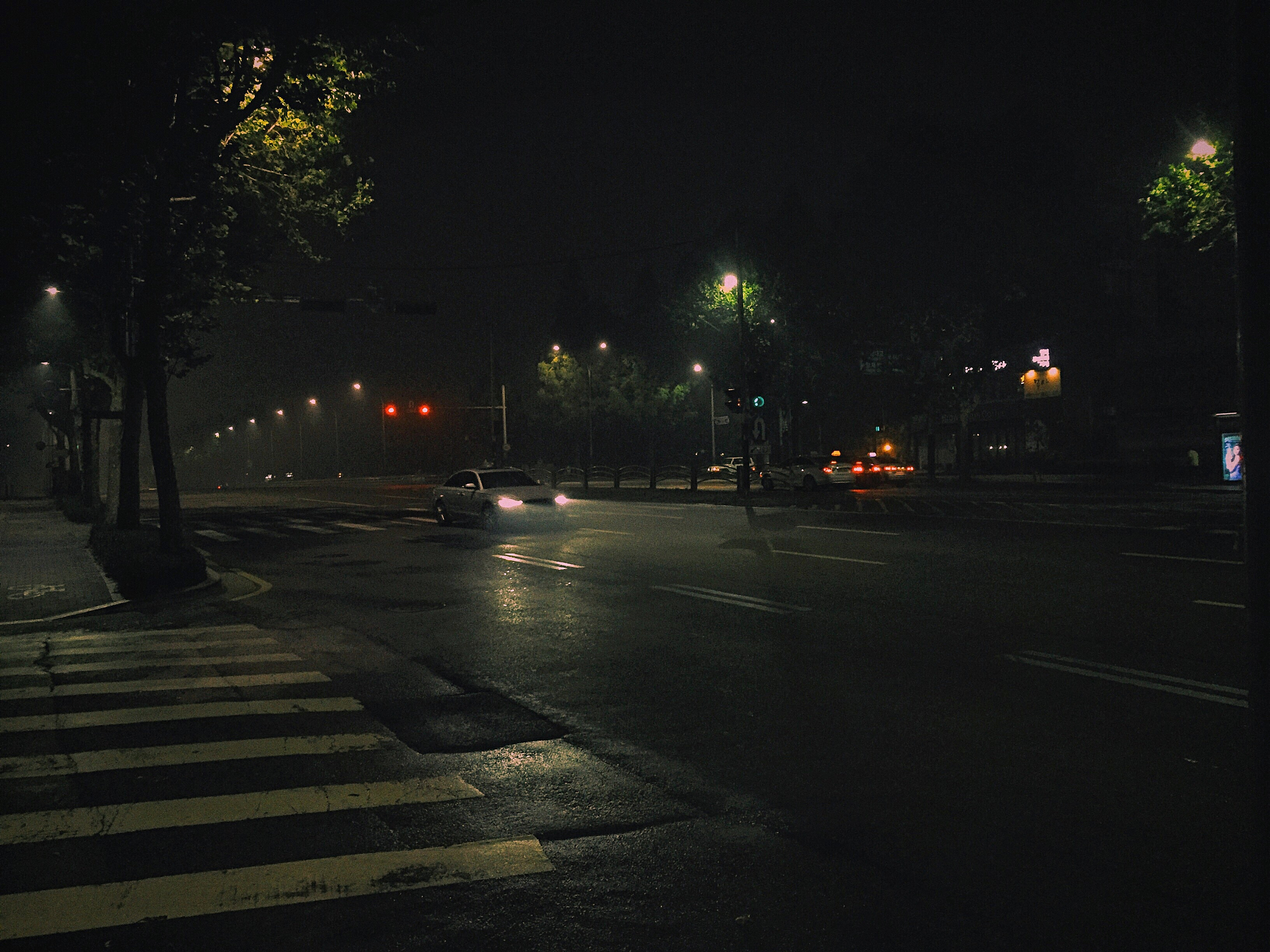 illuminated city street at night