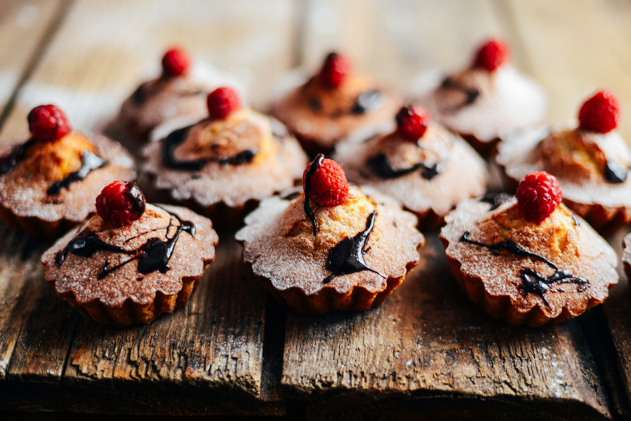 delicious chocolate cupcakes with berries on wodeen table, top v
