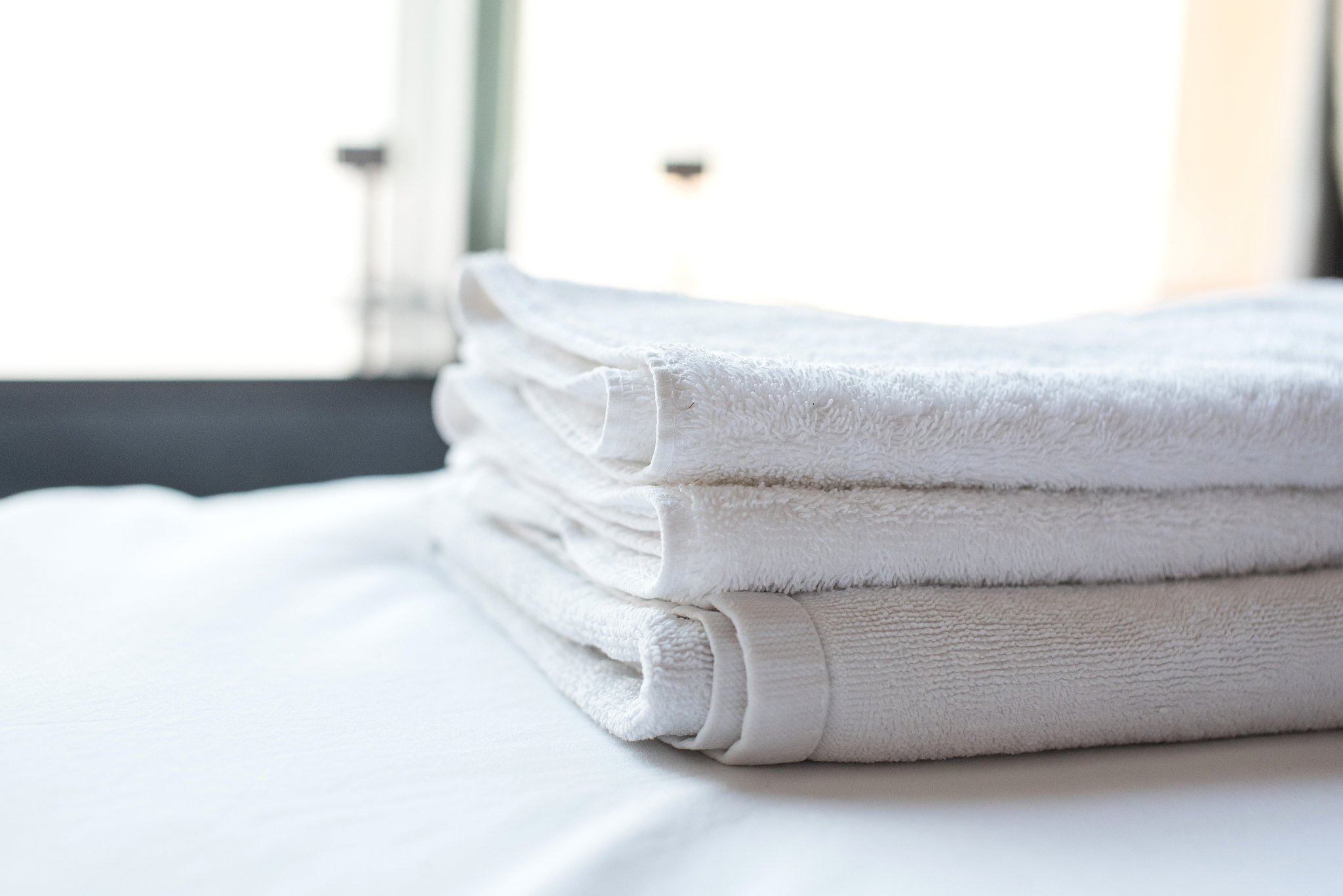 place a towel on the bed in the hotel.