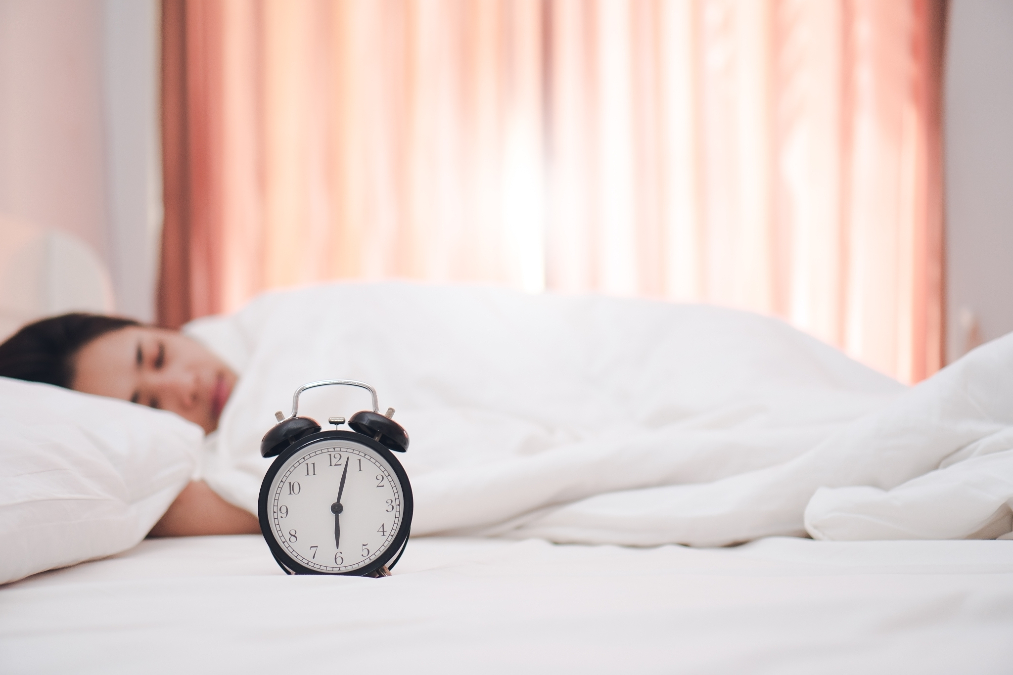 young woman sleeping on bed at home