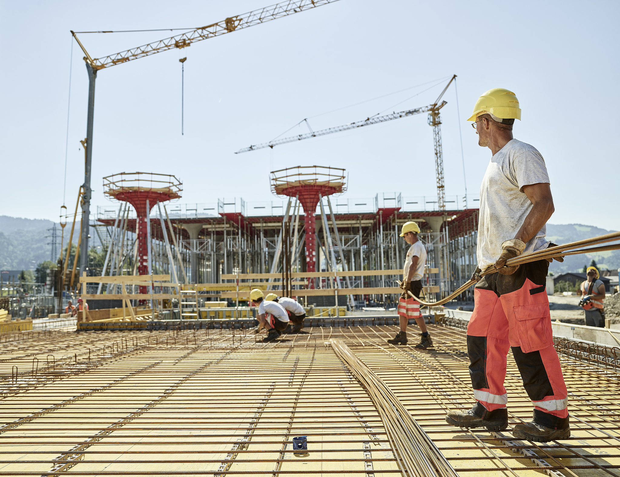 workers on construction site preparing iron rods