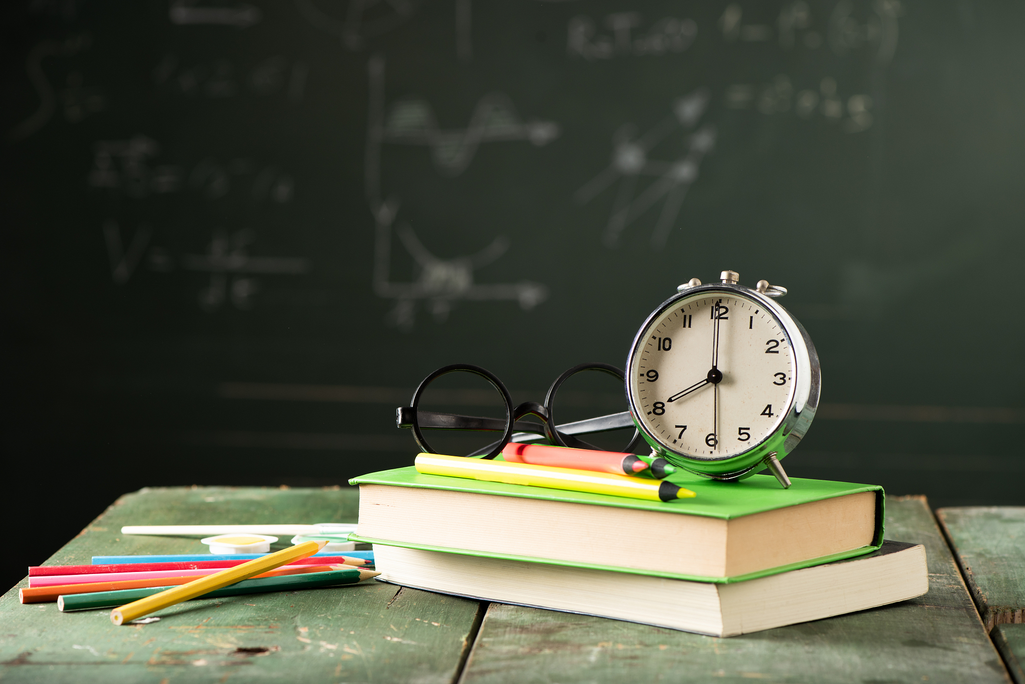 back to school background with books and alarm clock