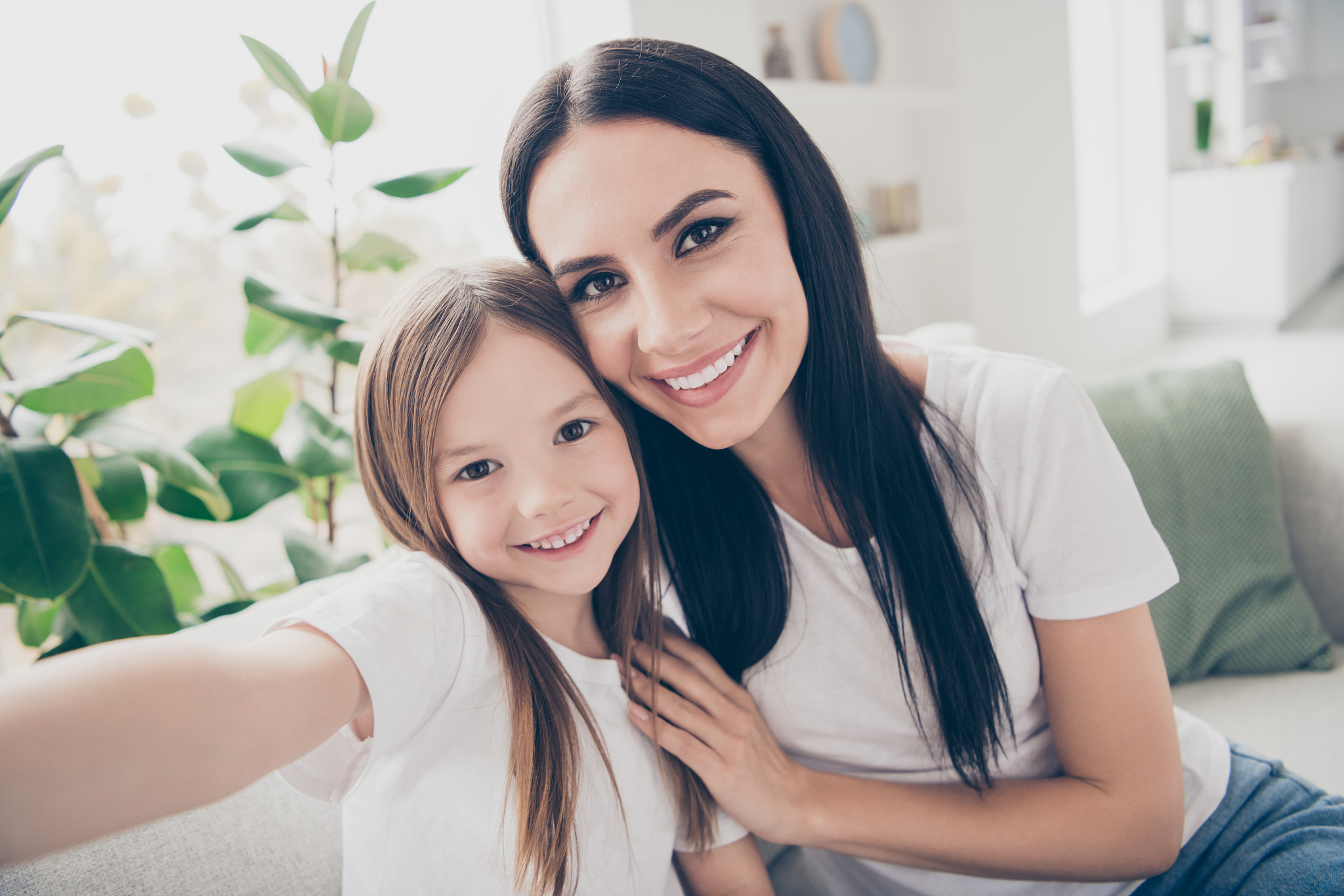 closeup photo of cute small girl and young attractive mom huggin