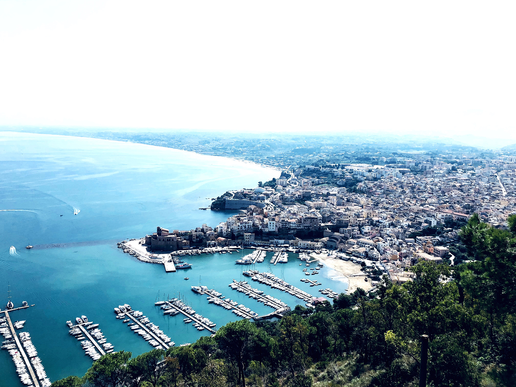 high angle view of city by sea against sky