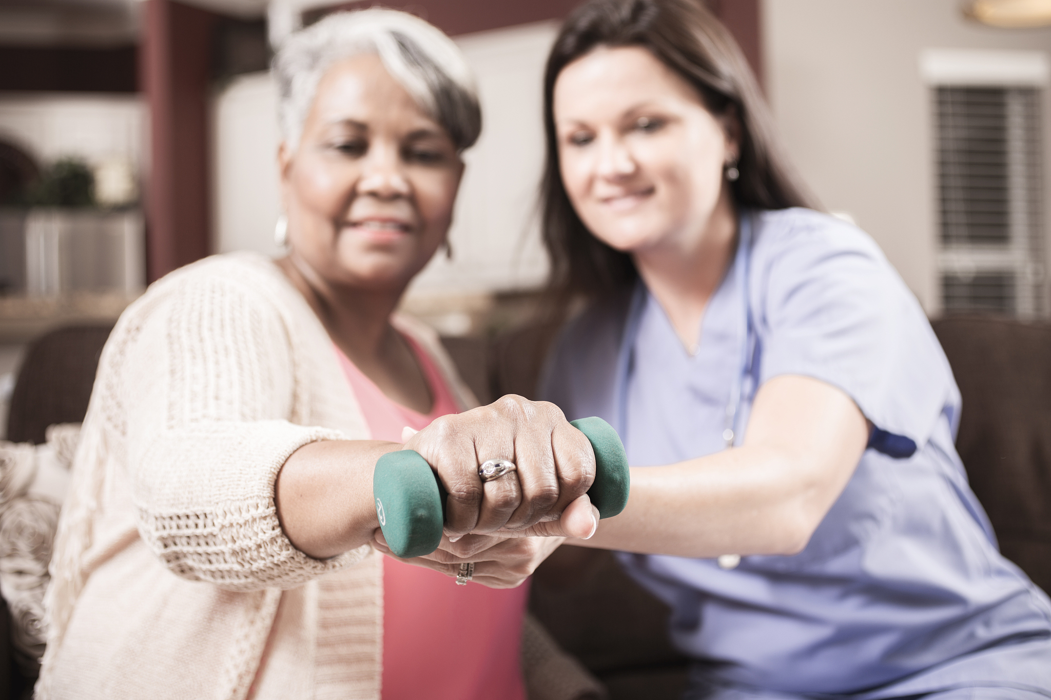 home healthcare nurse, physical therapy with senior adult woman.