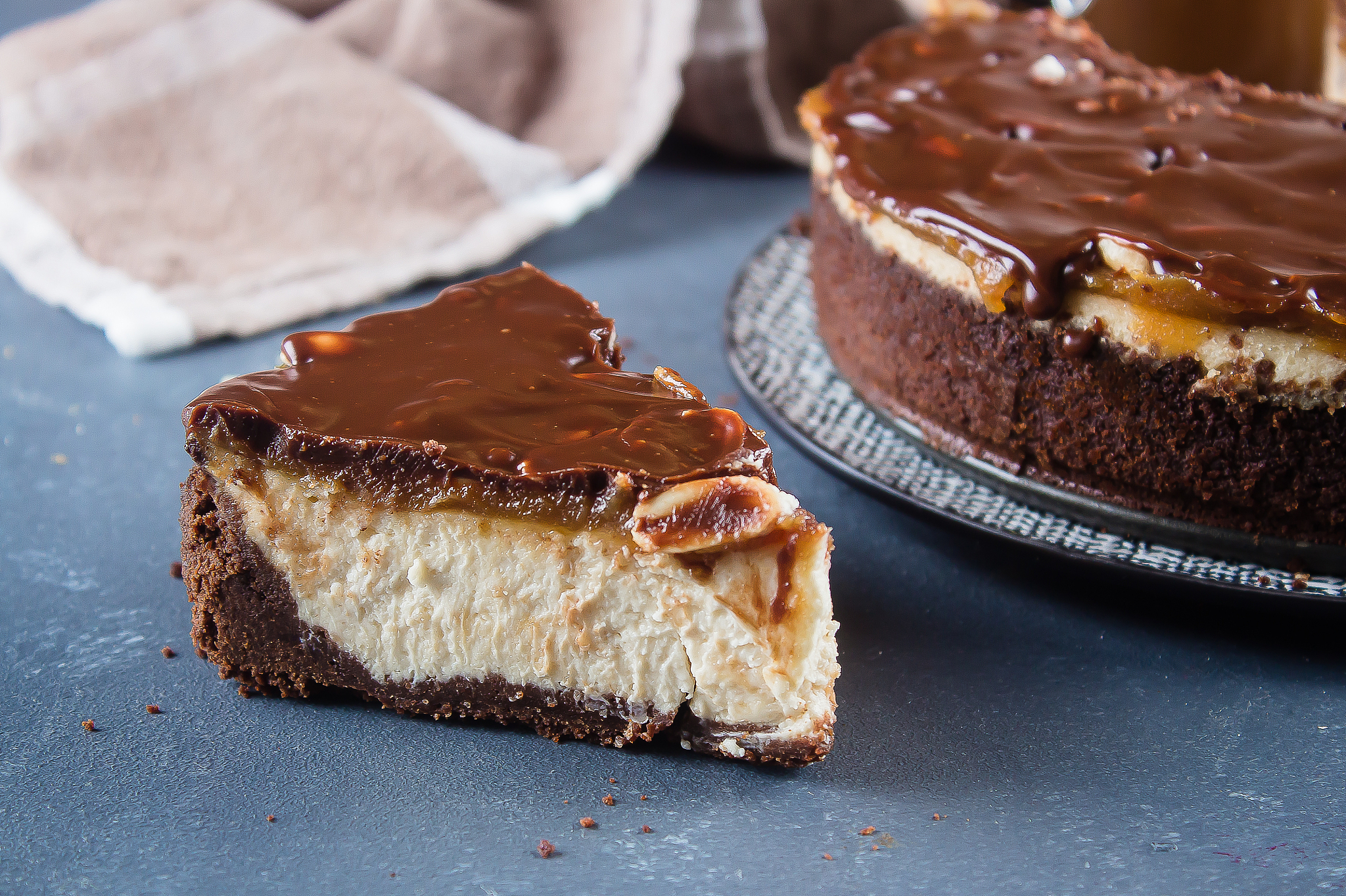 a piece slice of heesecake snickers with chocolate, caramel, pea