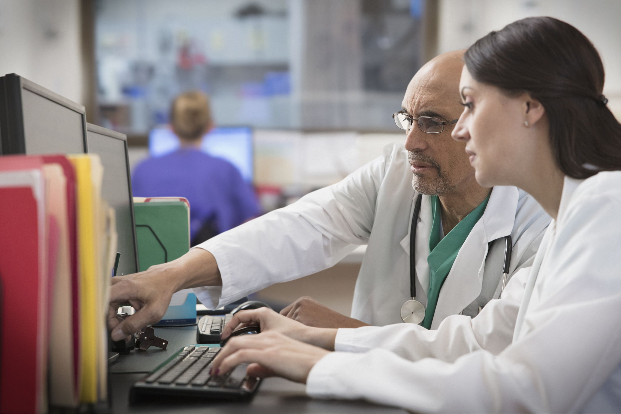 two doctors working at desk in hospital