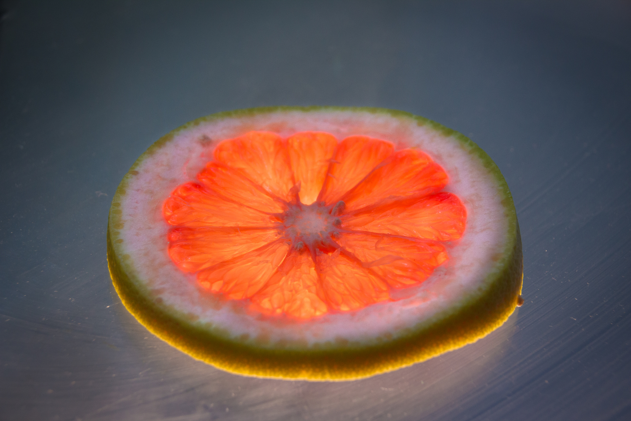 grapefruit slice on lighted glass