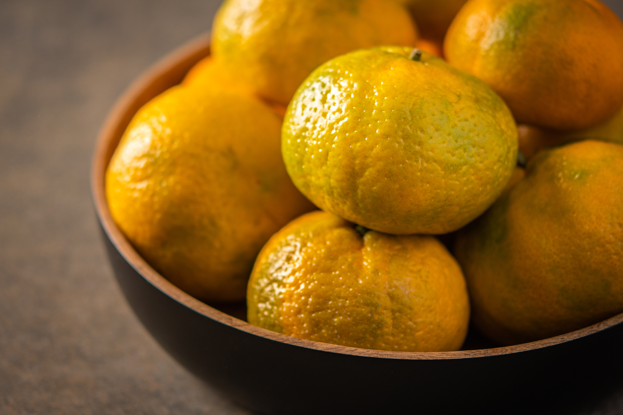 tangerines or mandarines in bamboo bowl close up