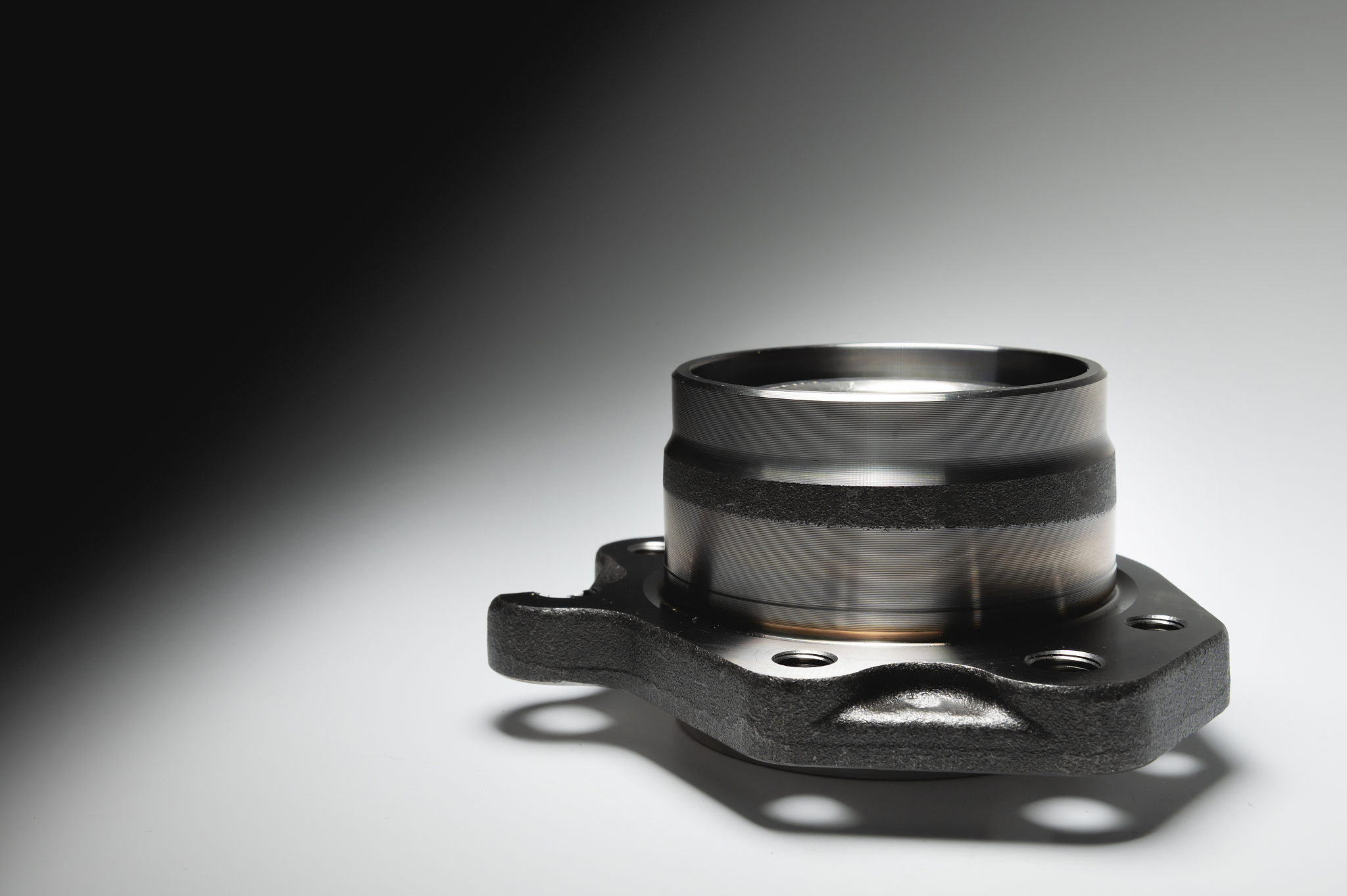 new wheel bearing in a metal housing on a black-white gradient b