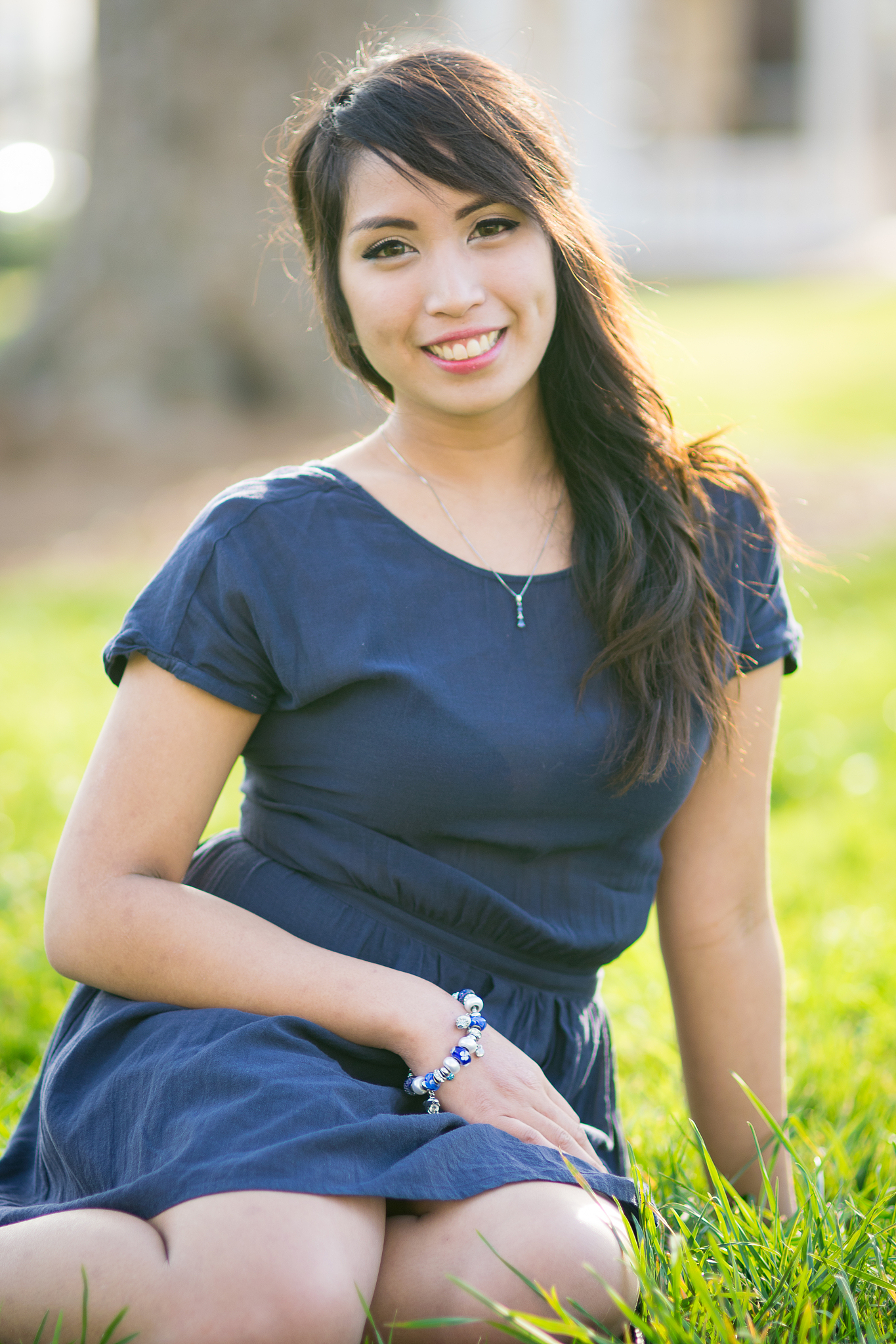 beautiful woman sitting in the grass