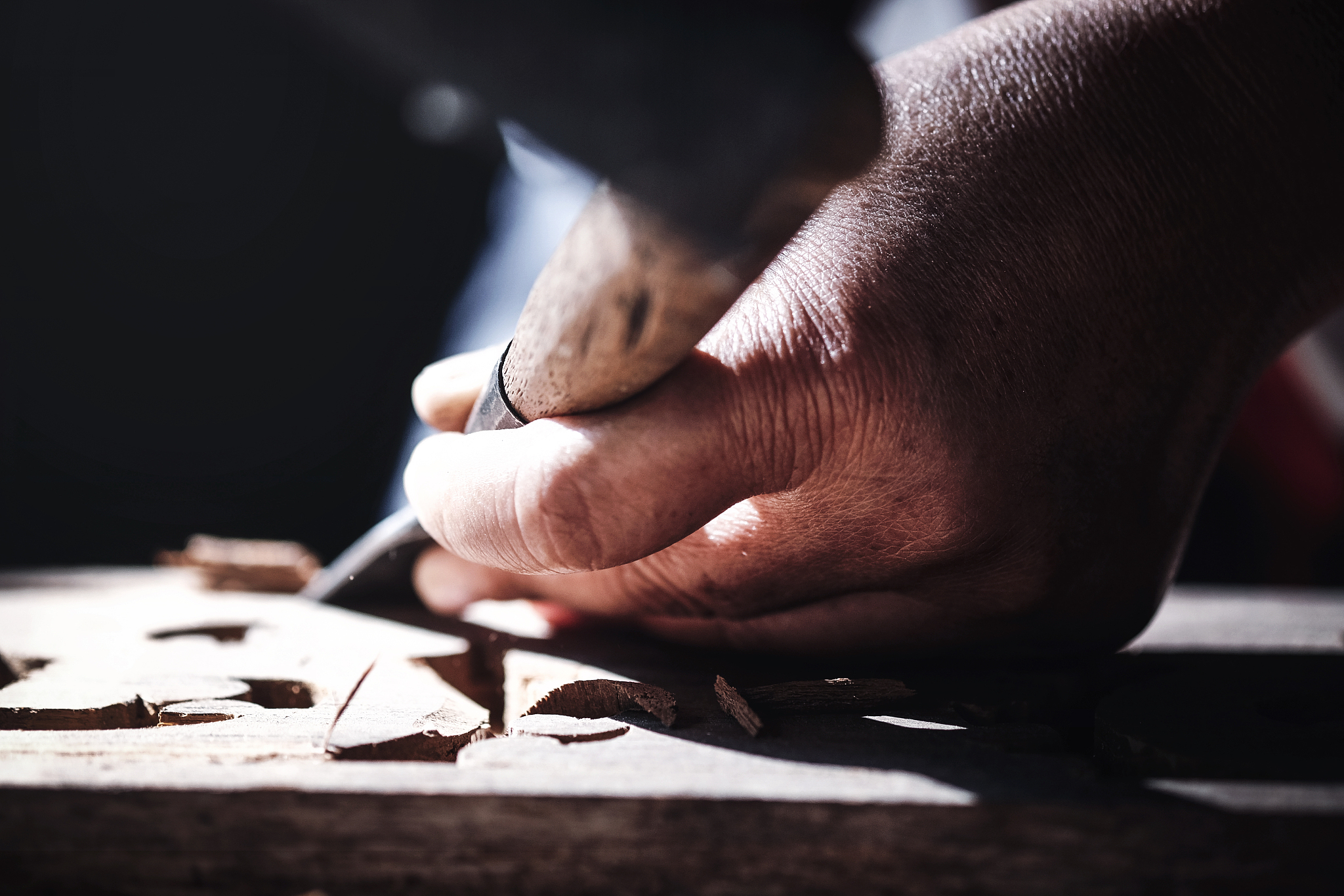 hand of women with wood carving tools to create handcraft art.