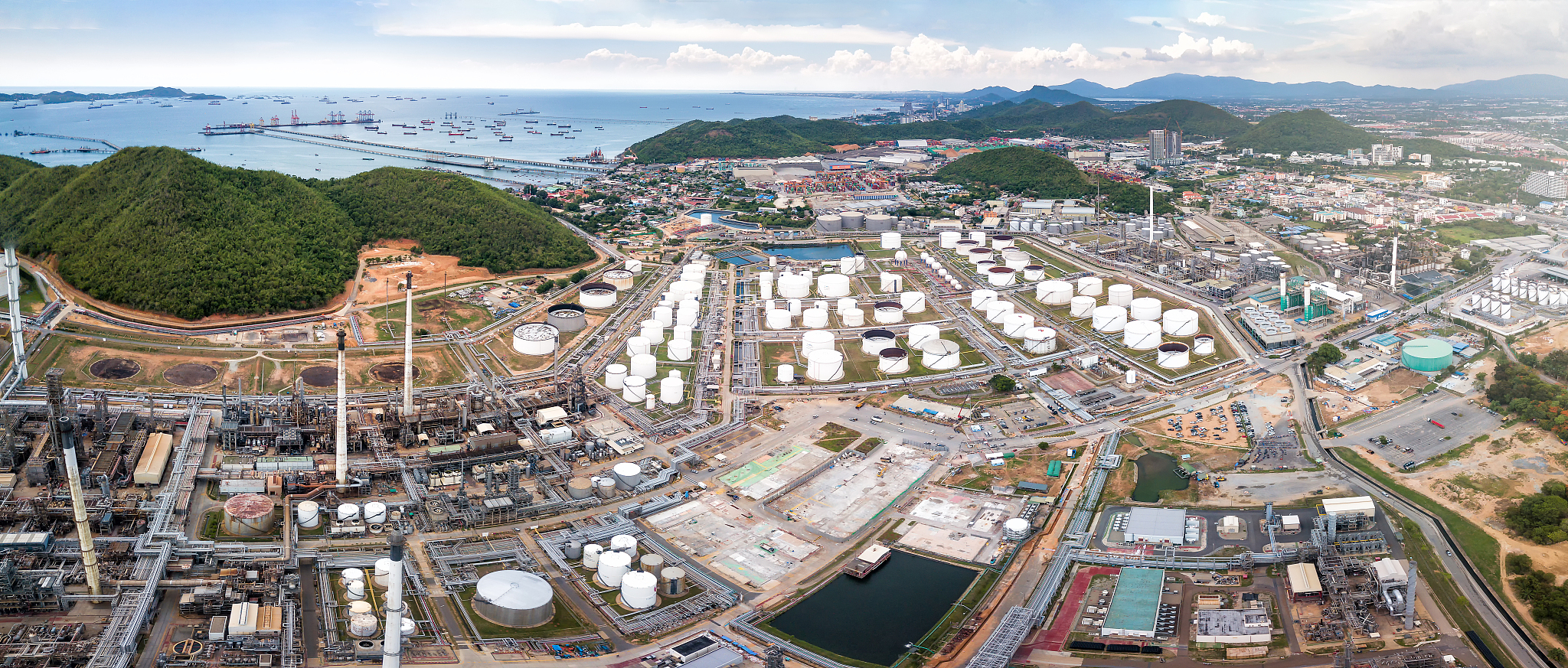 aerial view of oil refinery and power plant station near the sea