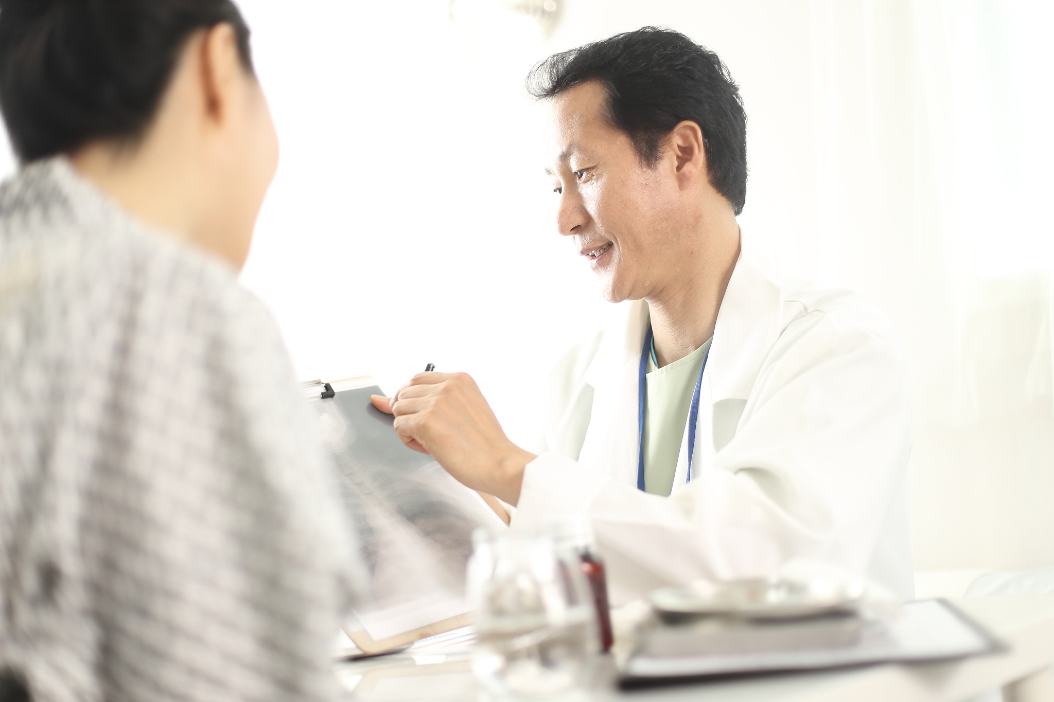 doctor showing x rays to his patient in medical office