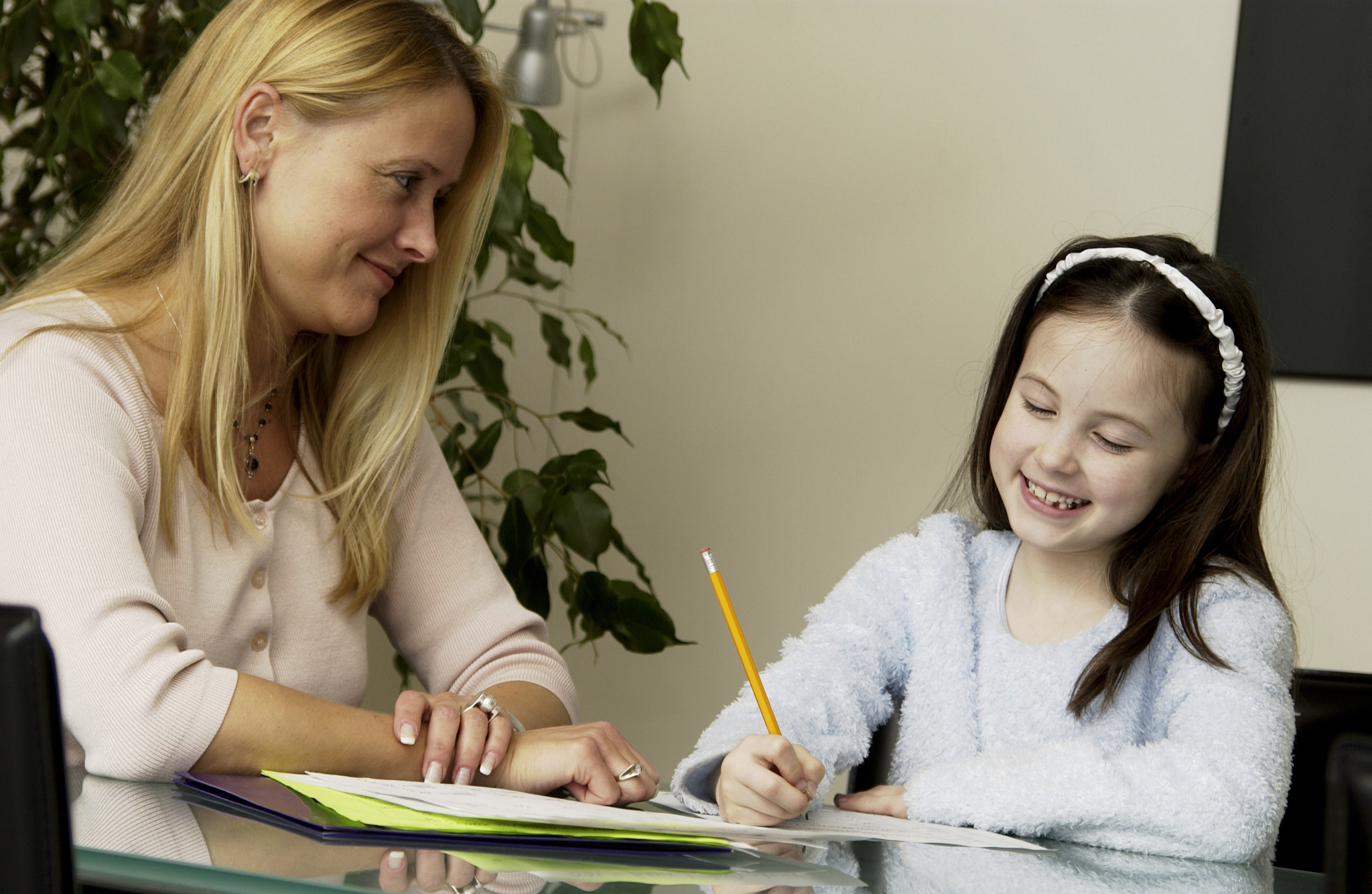 mother helping daughter with homework