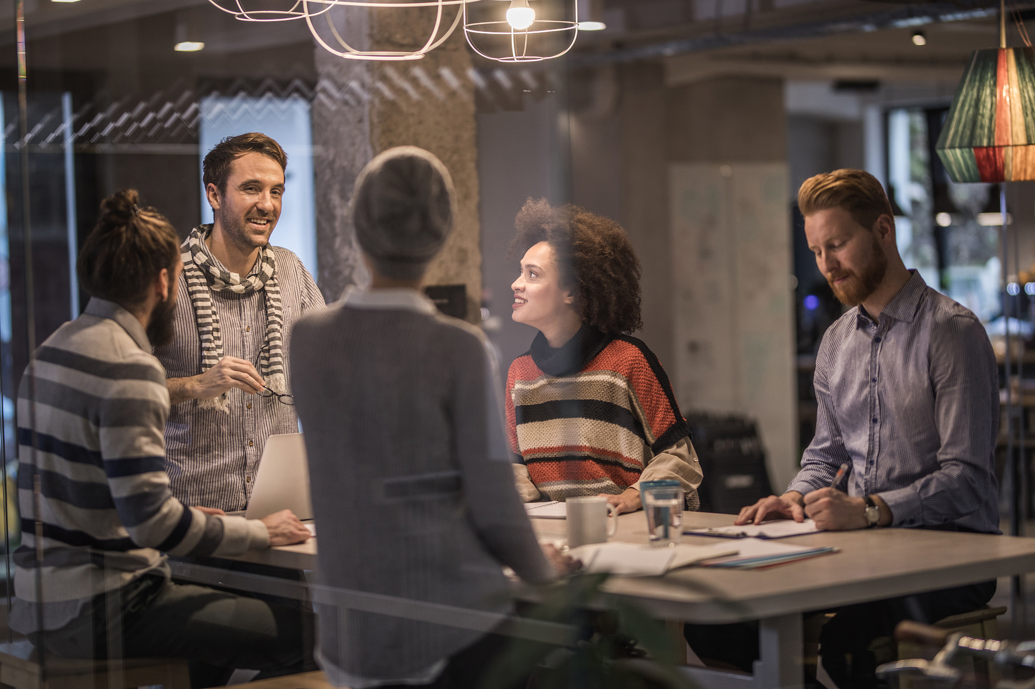 happy business colleagues talking while working in the office.