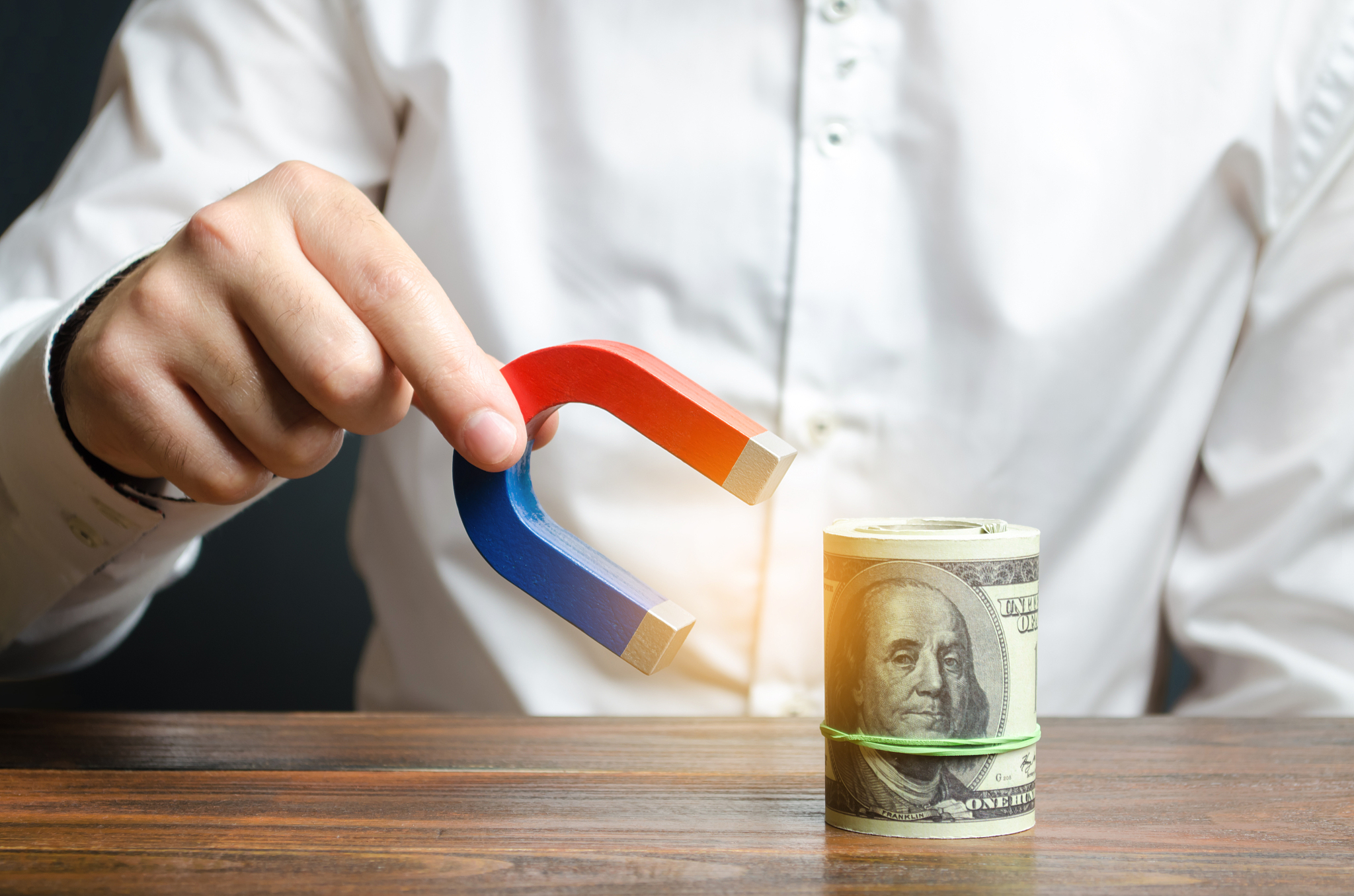businessman attracts money with a magnet. attracting money and i