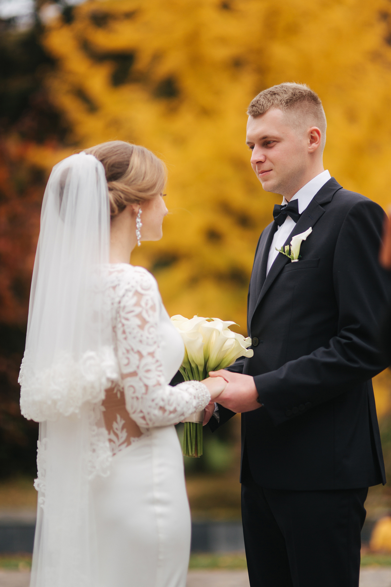 beautiful autumn in the park. just married couple walking by the