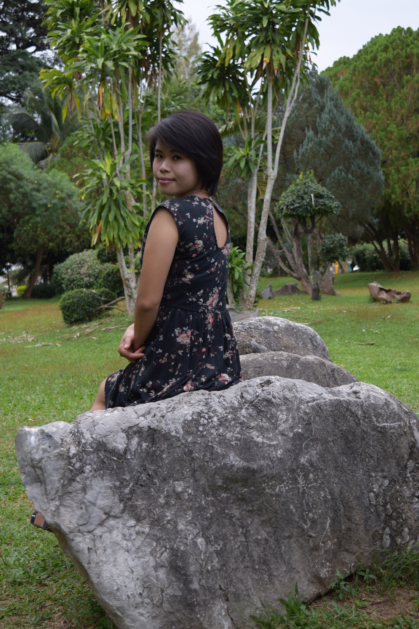 portrait of woman sitting on rock