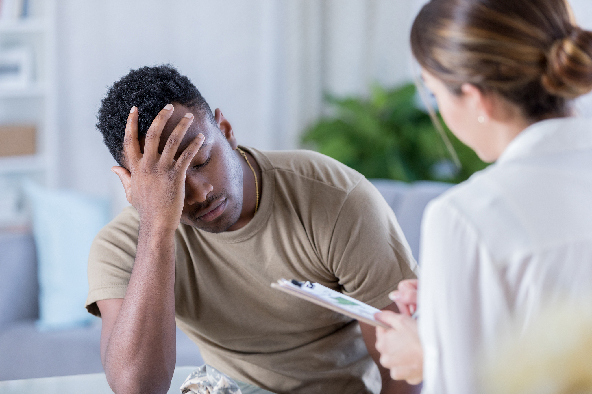 upset soldier talks with therapist