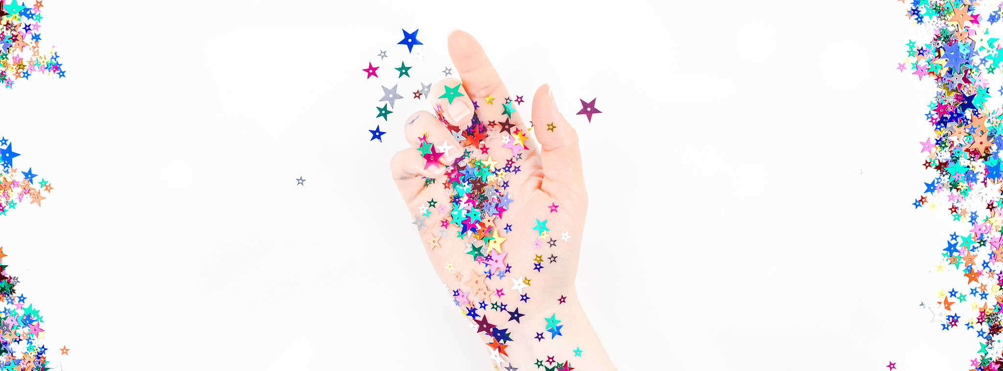 woman hand with festive color star confetti