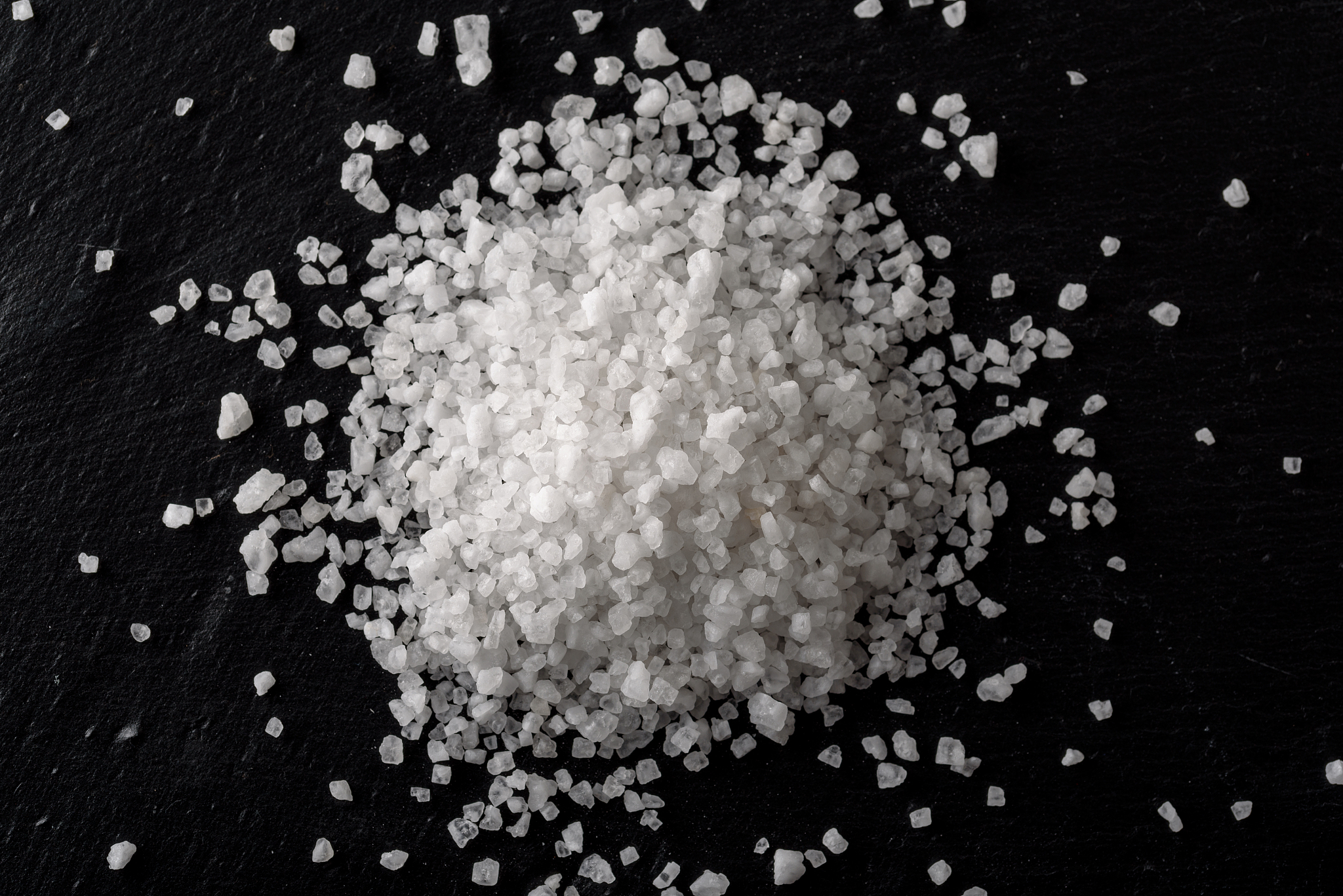 sea white salt on black stone background