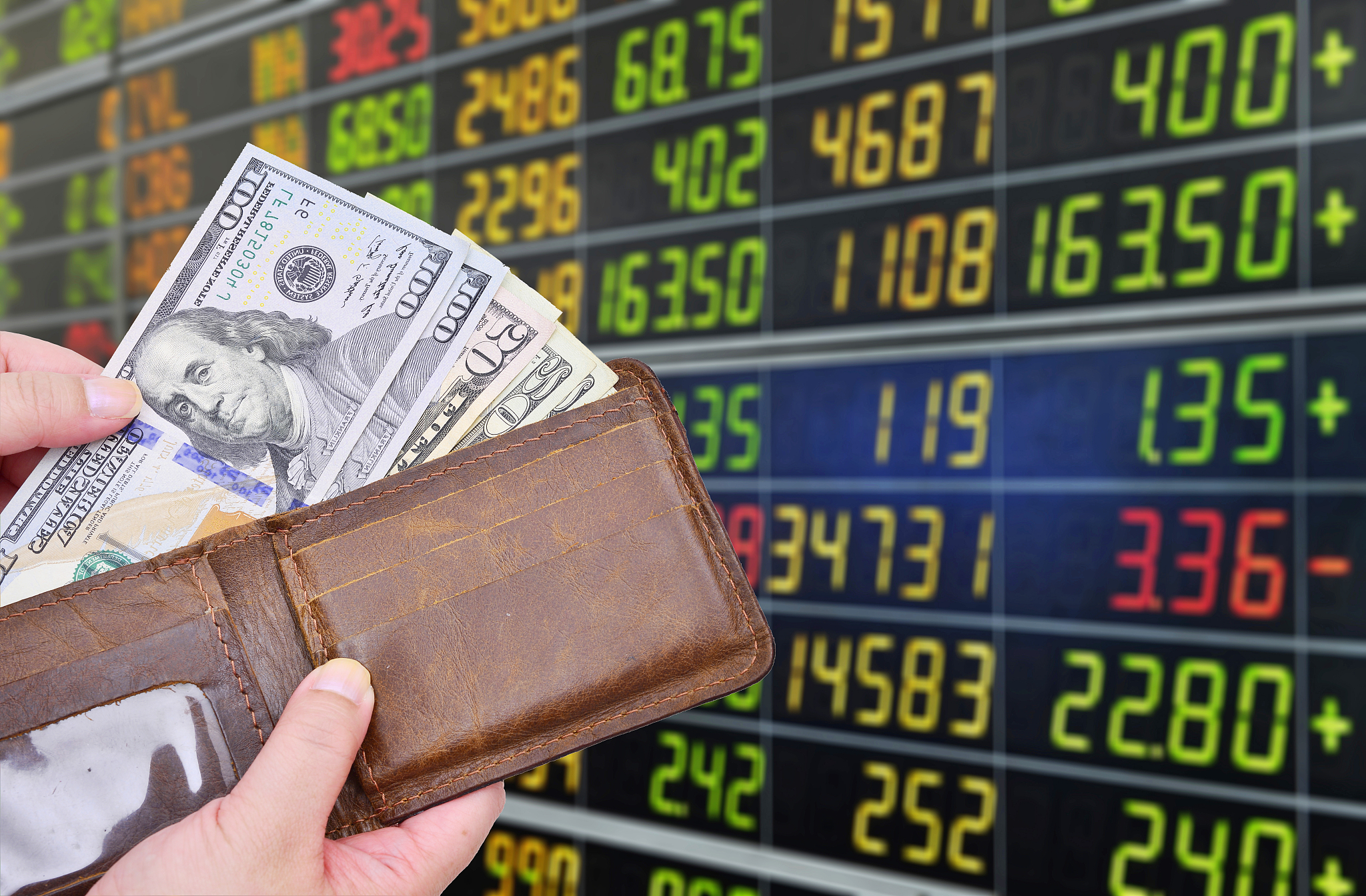dollar banknotes on monitor stock market background.