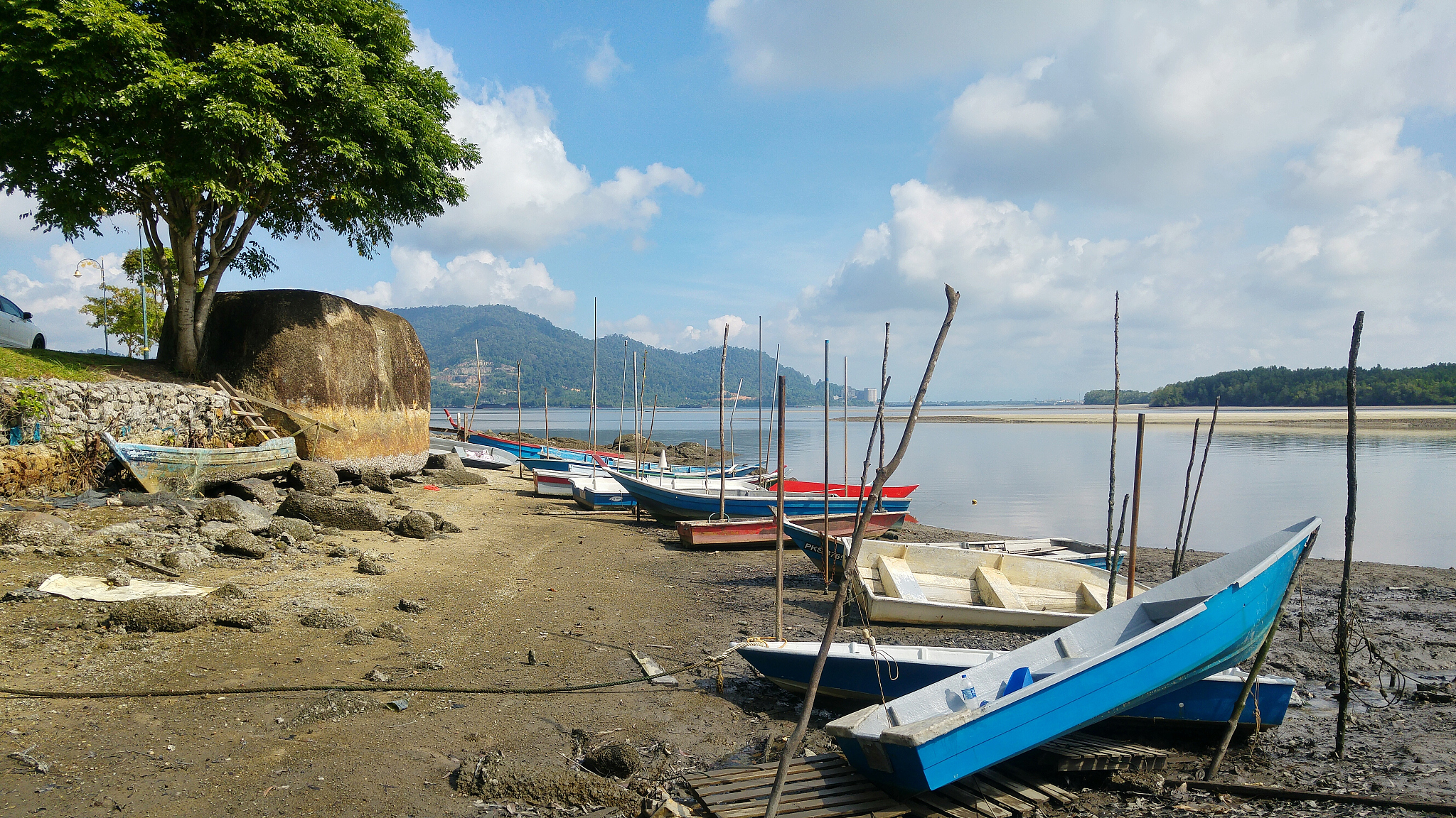 boats moored at beach against sky