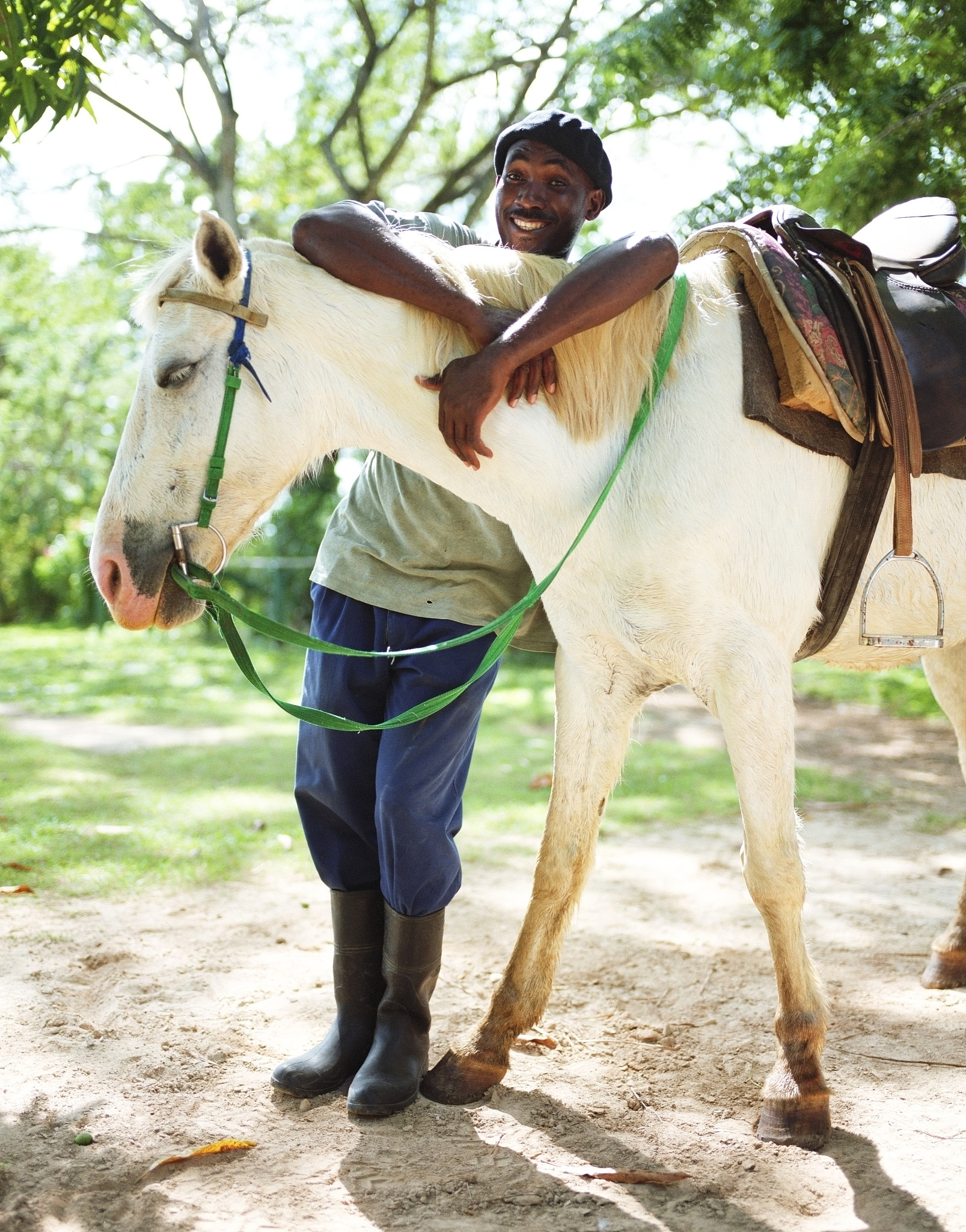 man with arms on horse, smiling, portrait