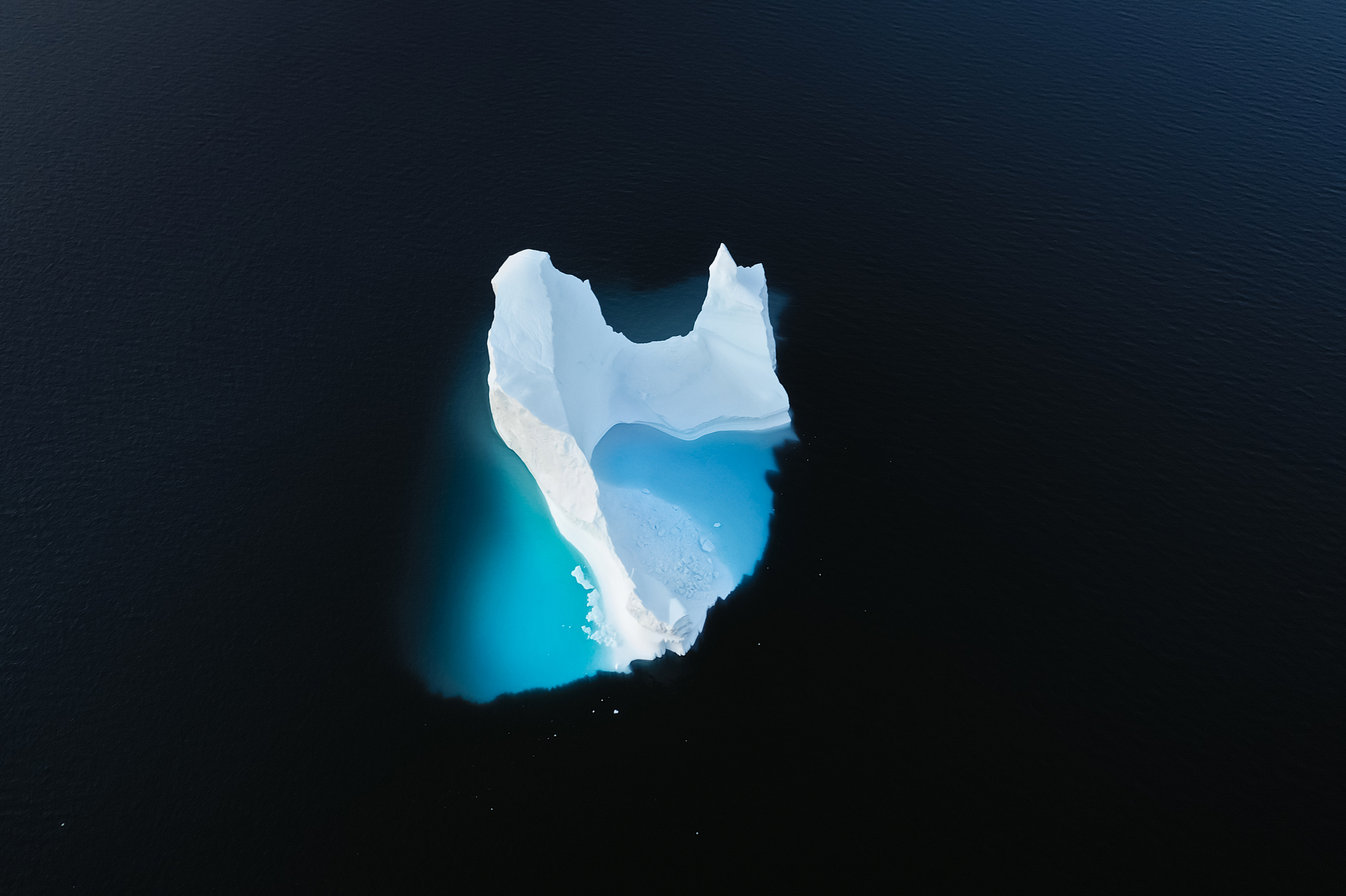aerial view of large glacier and iceberg