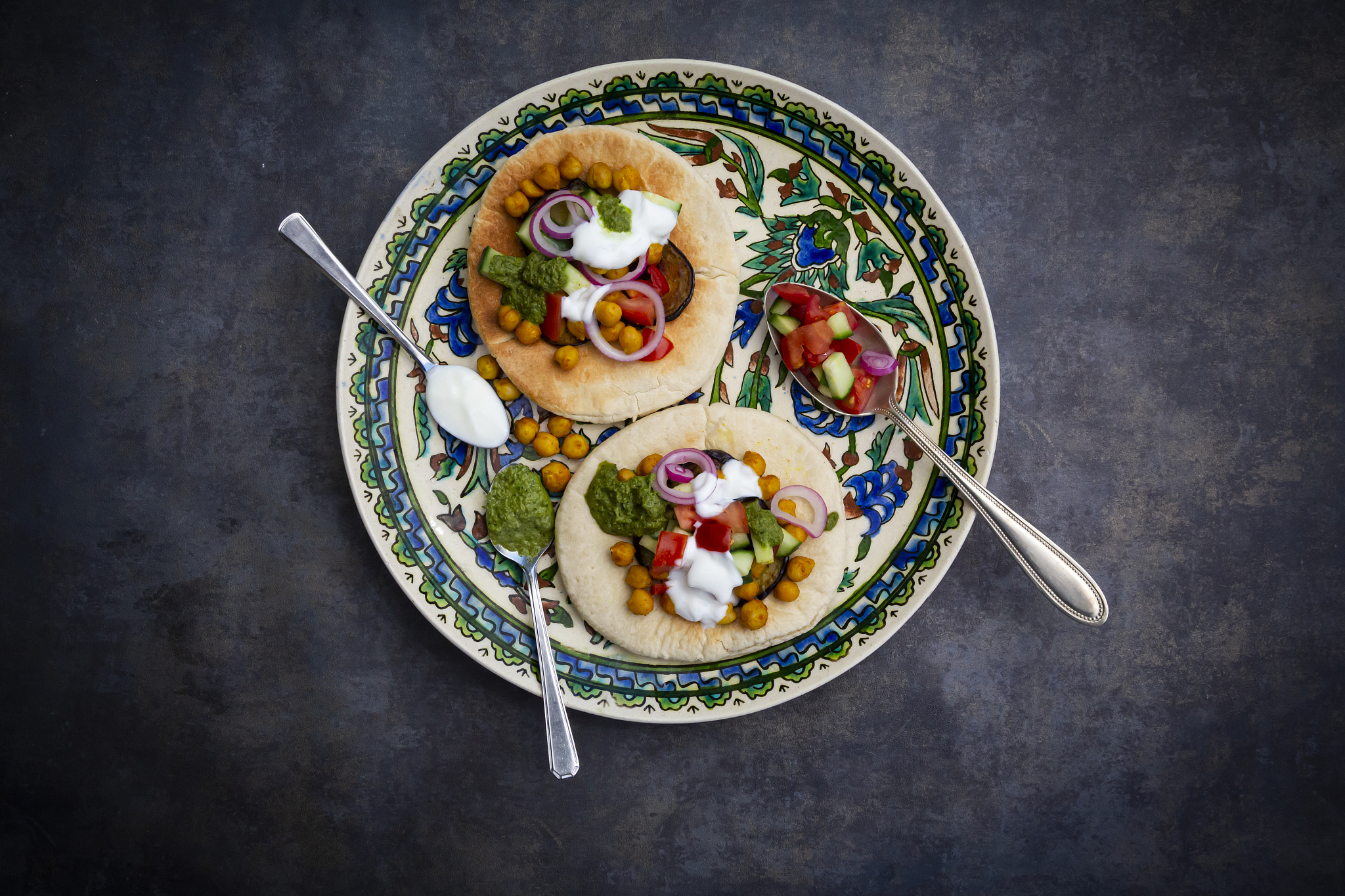 garnished sabich, pita bread with fresh vegetables, onions, yogu
