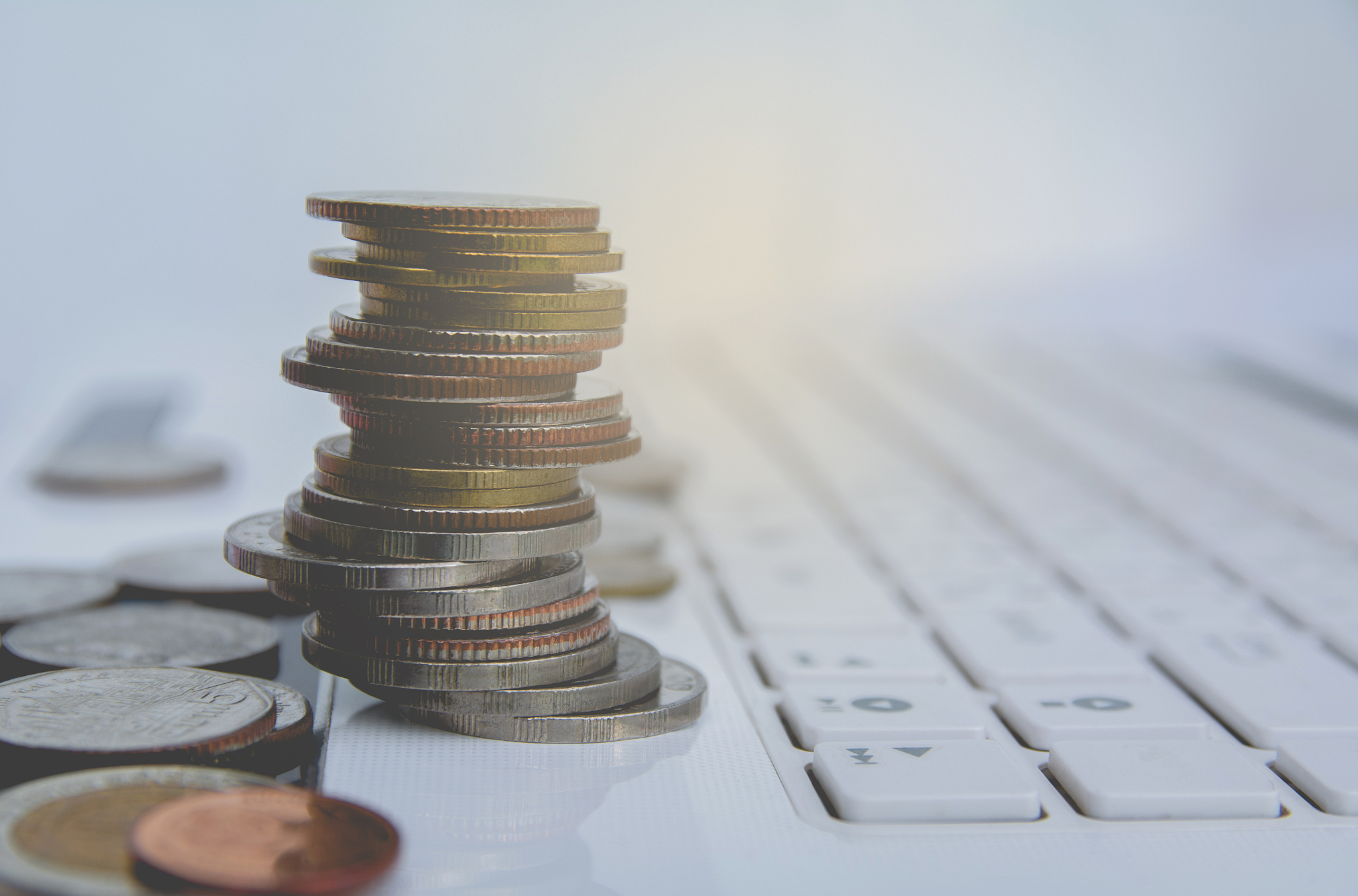 stack coins on white laptop, computer. financial and saving conc
