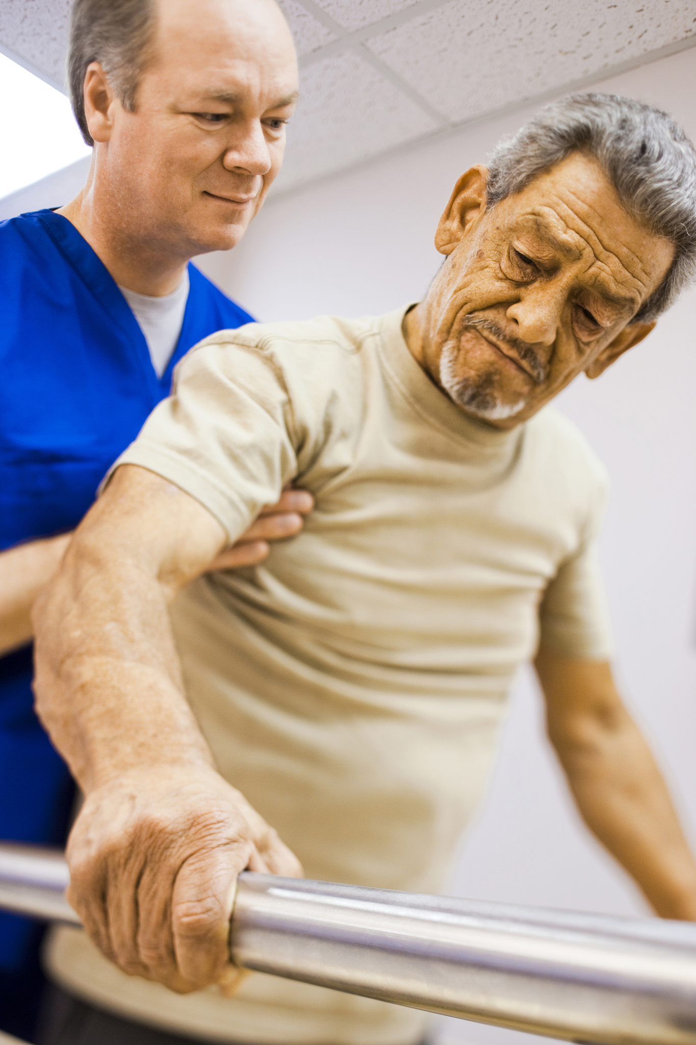 physical therapist holding a patient while walking