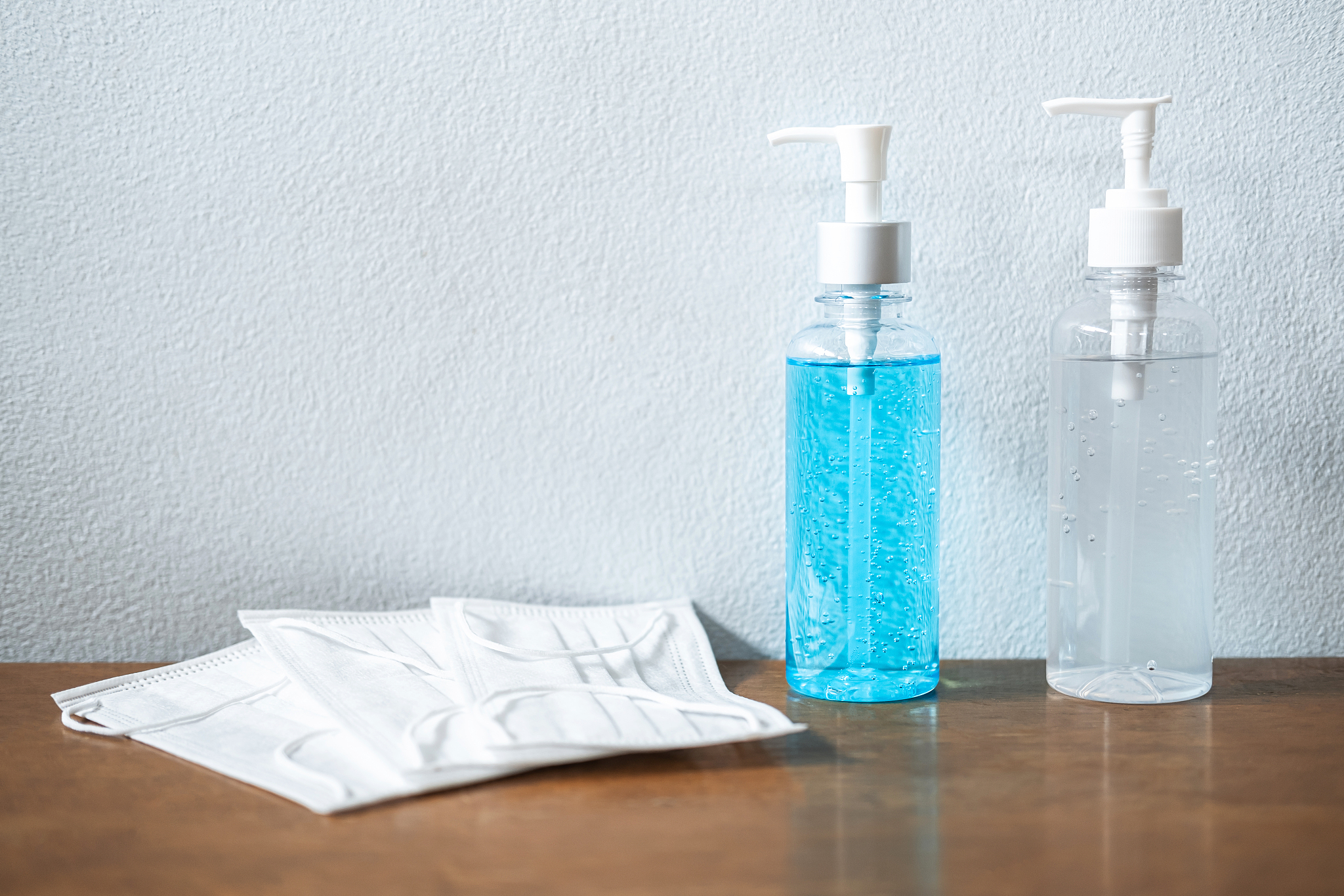 image of medical surgical masks and alcohol sanitizer hand gel f