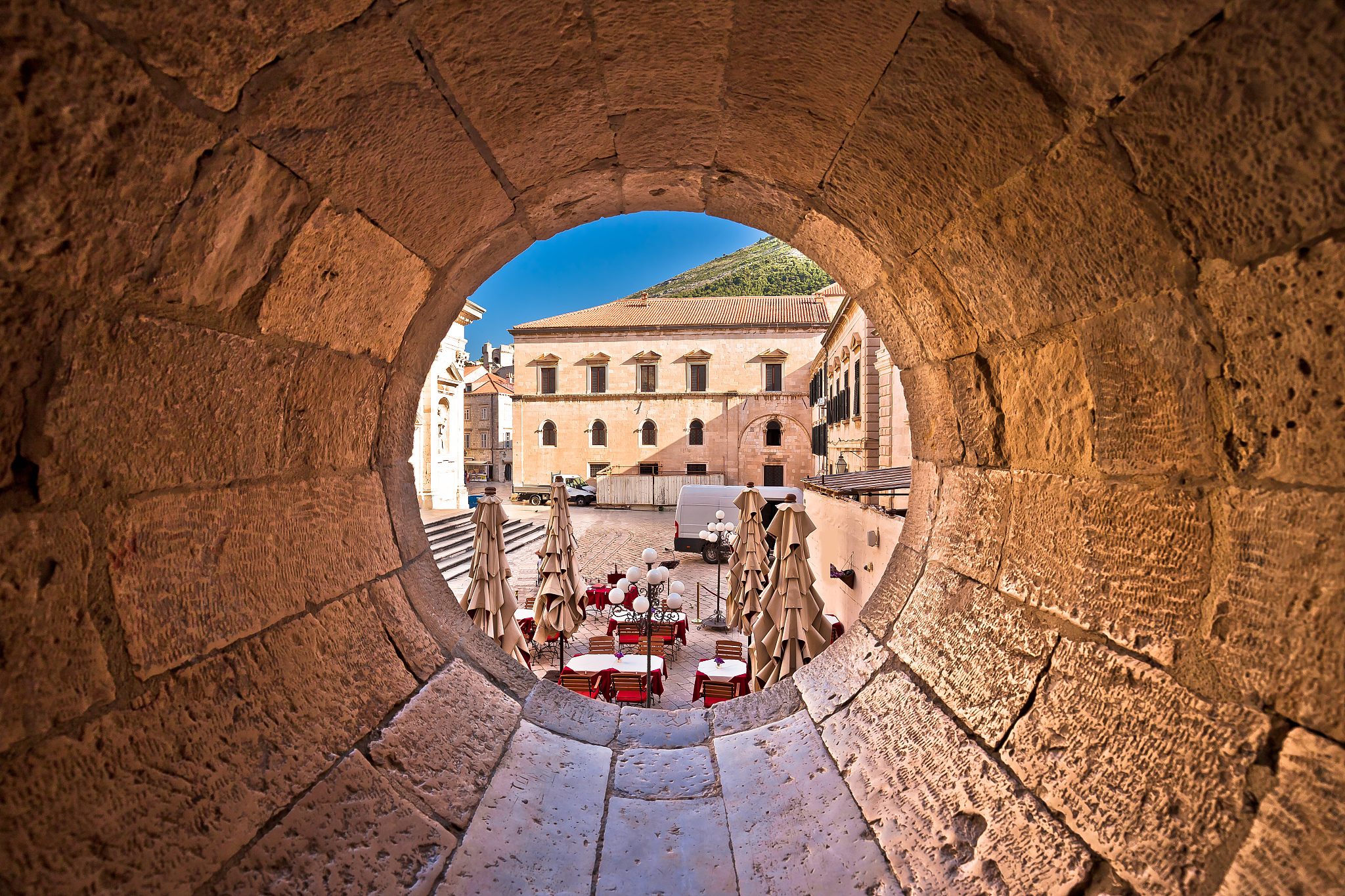 dubrovnik historic street view through stone carved window