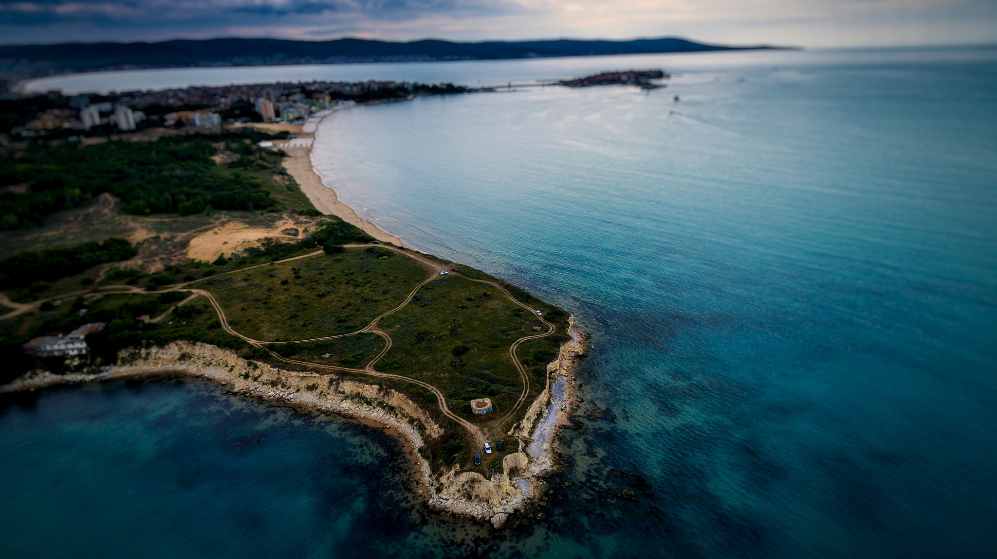 aerial view of city by sea against sky