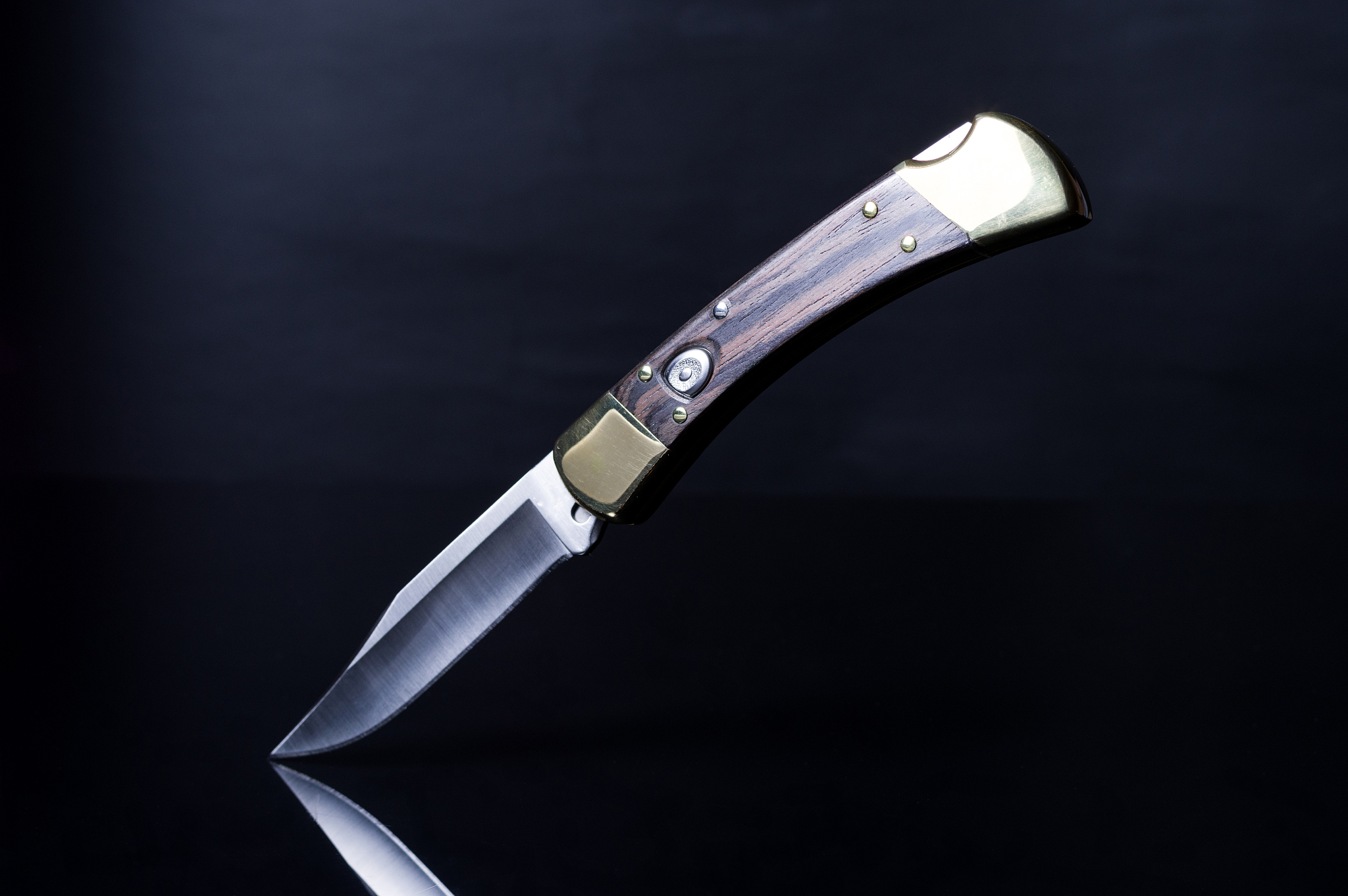 knife with a button on the handle. folding knife with a wooden h