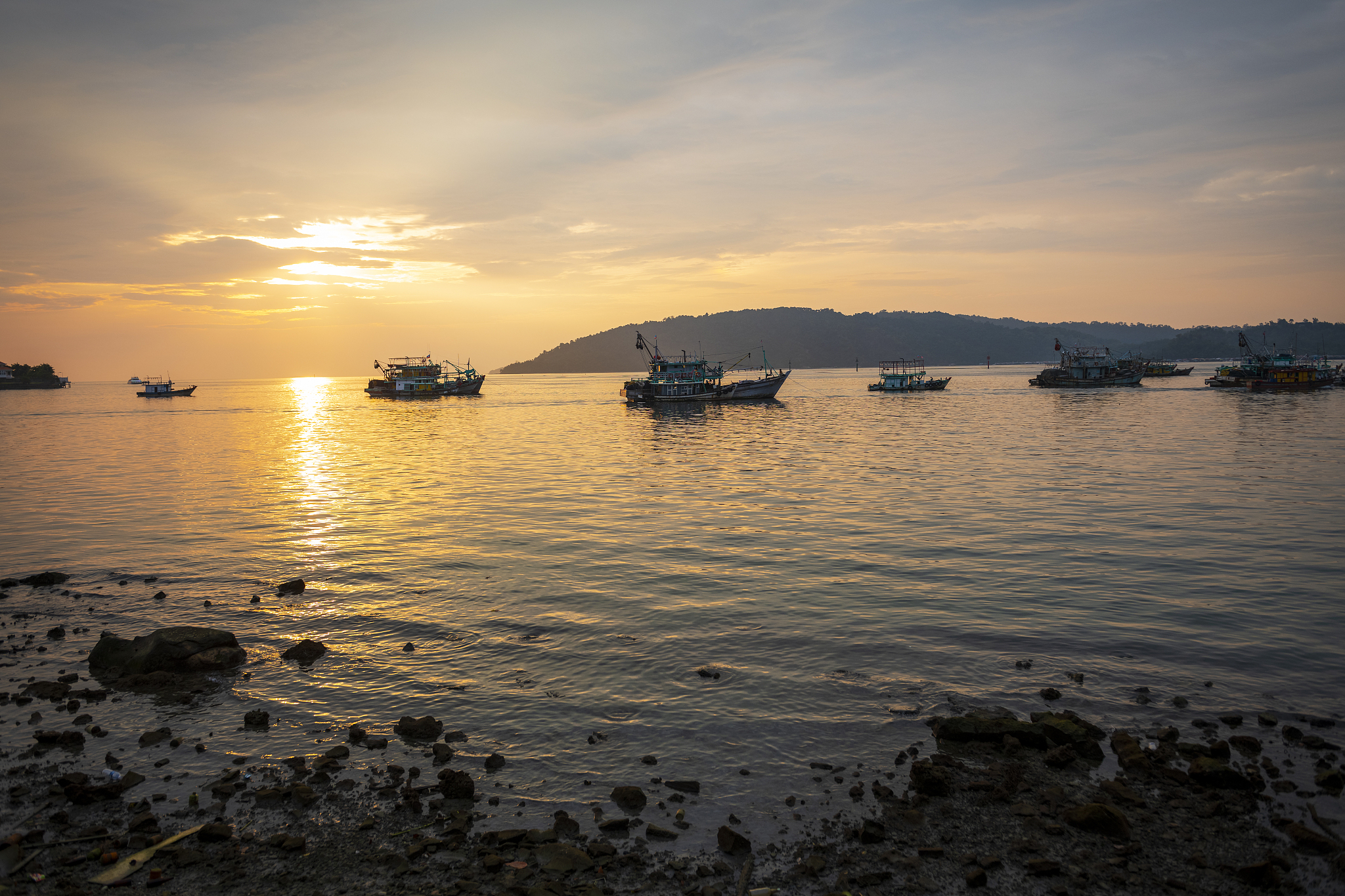 fishing boats at sunset in kota kinabalu, sabah, malaysia