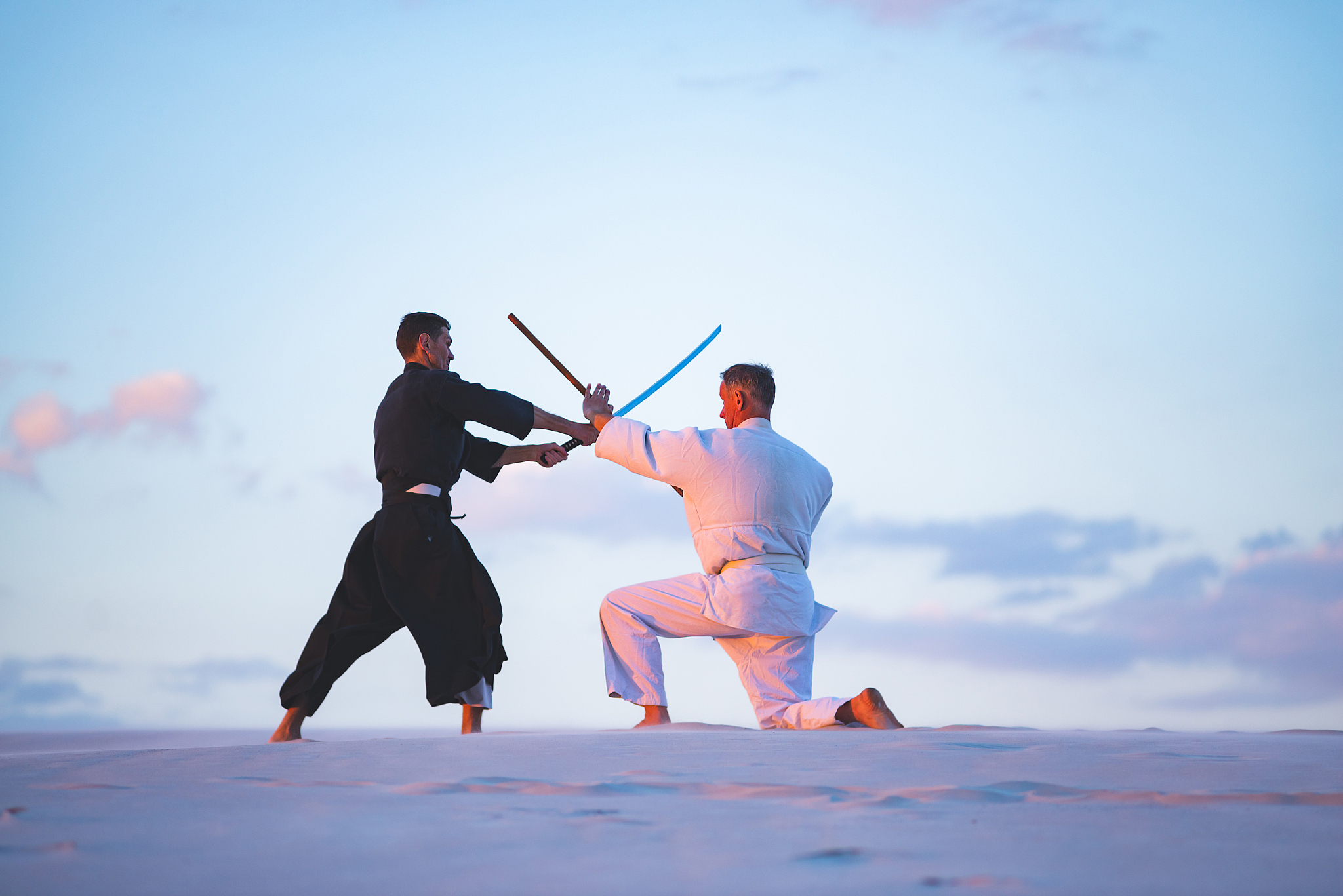 concentrated men, in japanese clothes, are practicing martial ar