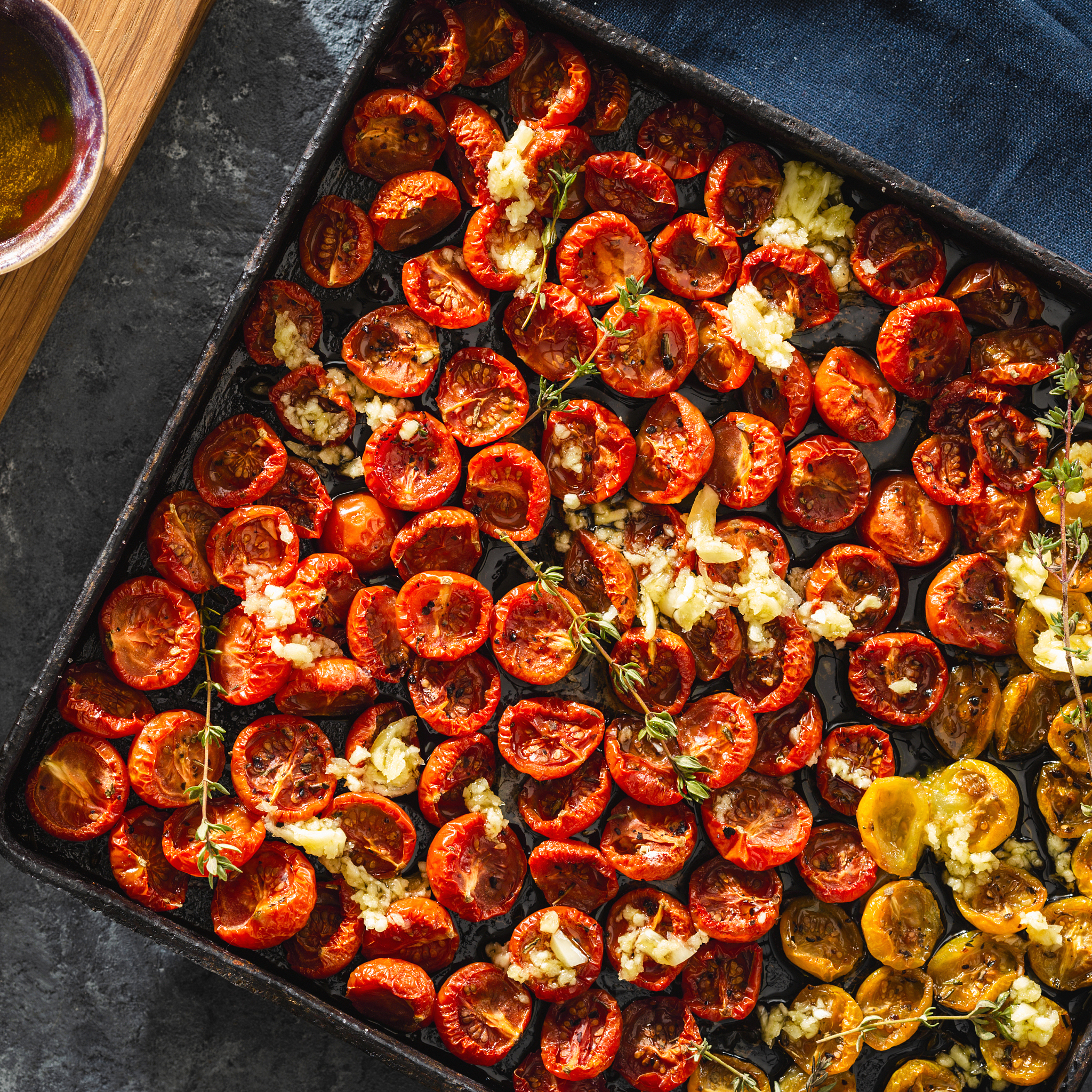 baked cherry tomatoes baking tray dark background top view