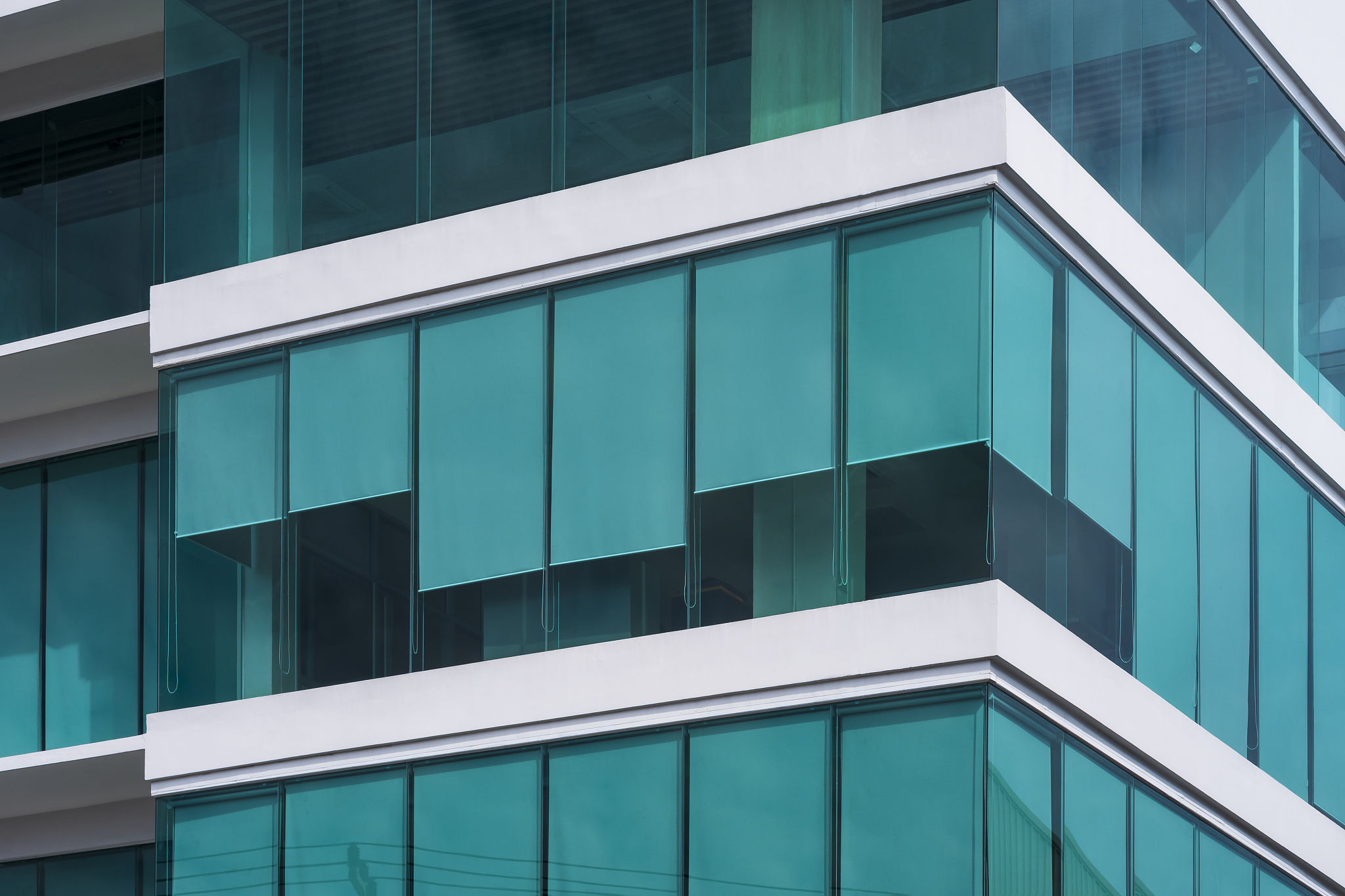 low angle view of blue roller blinds inside of modern glass offi
