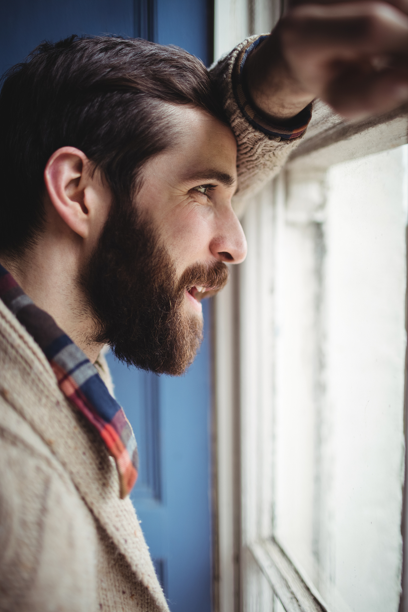 man looking through window