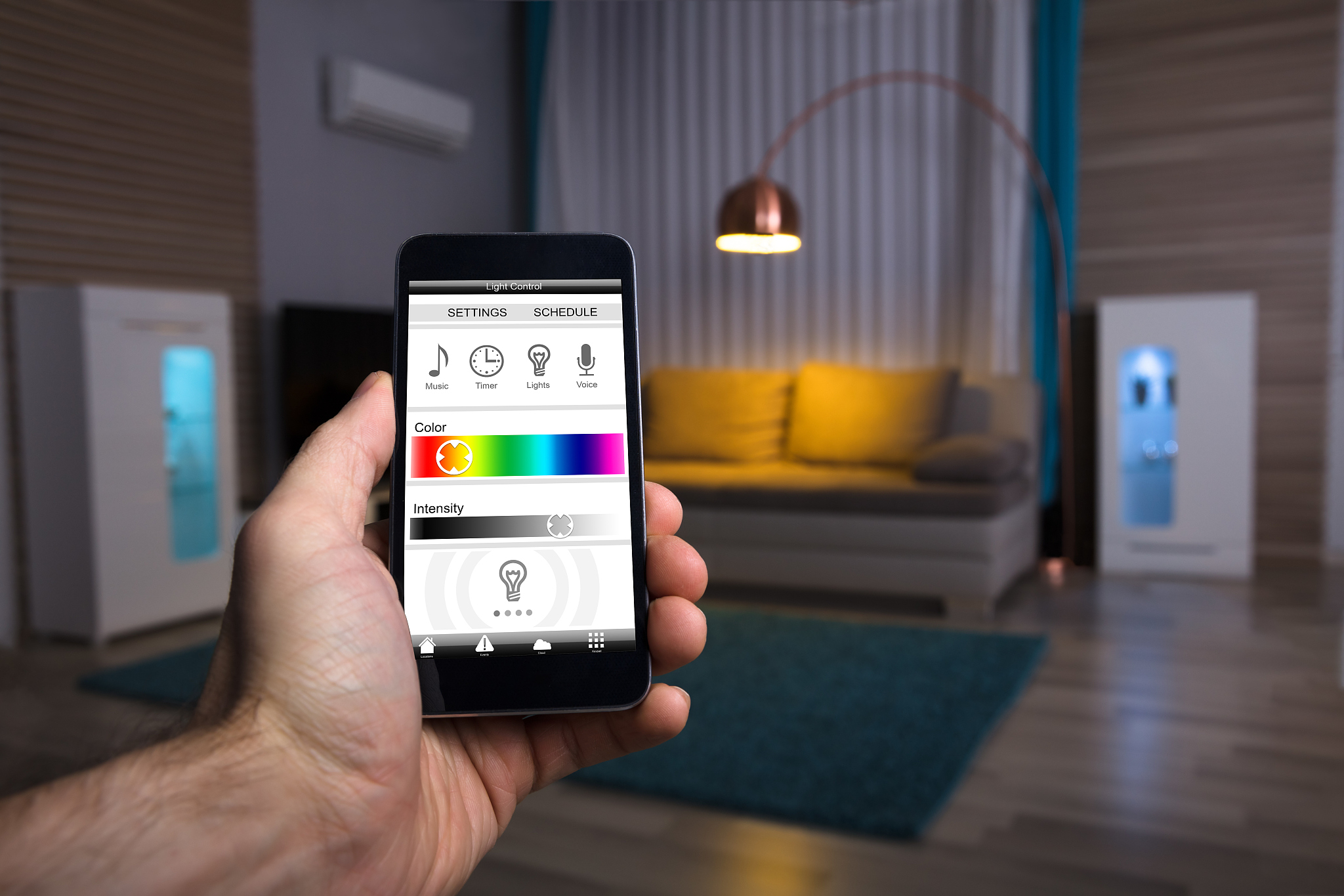 human hand adjusting electric light through mobile phone