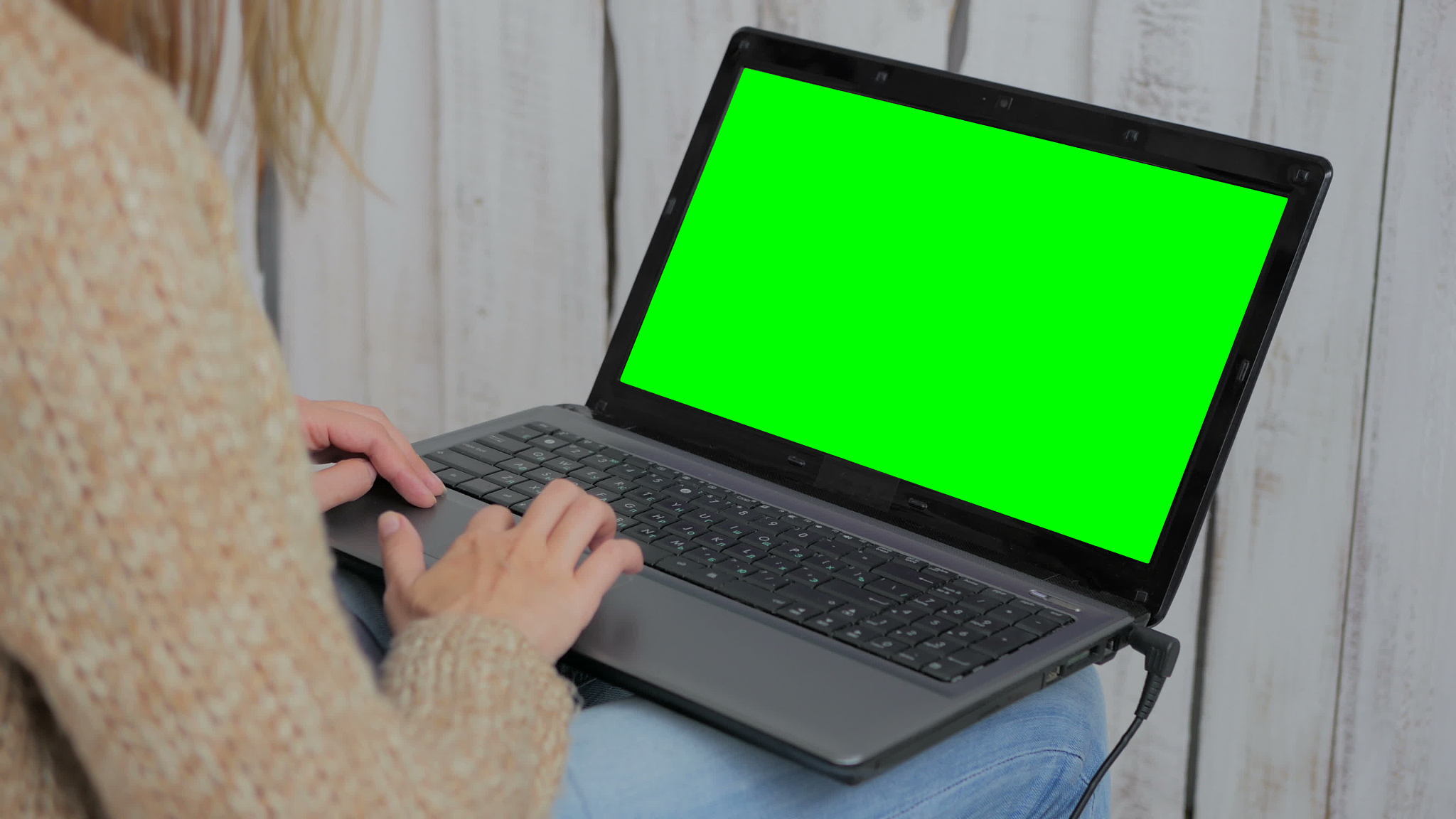 woman using laptop with green screen
