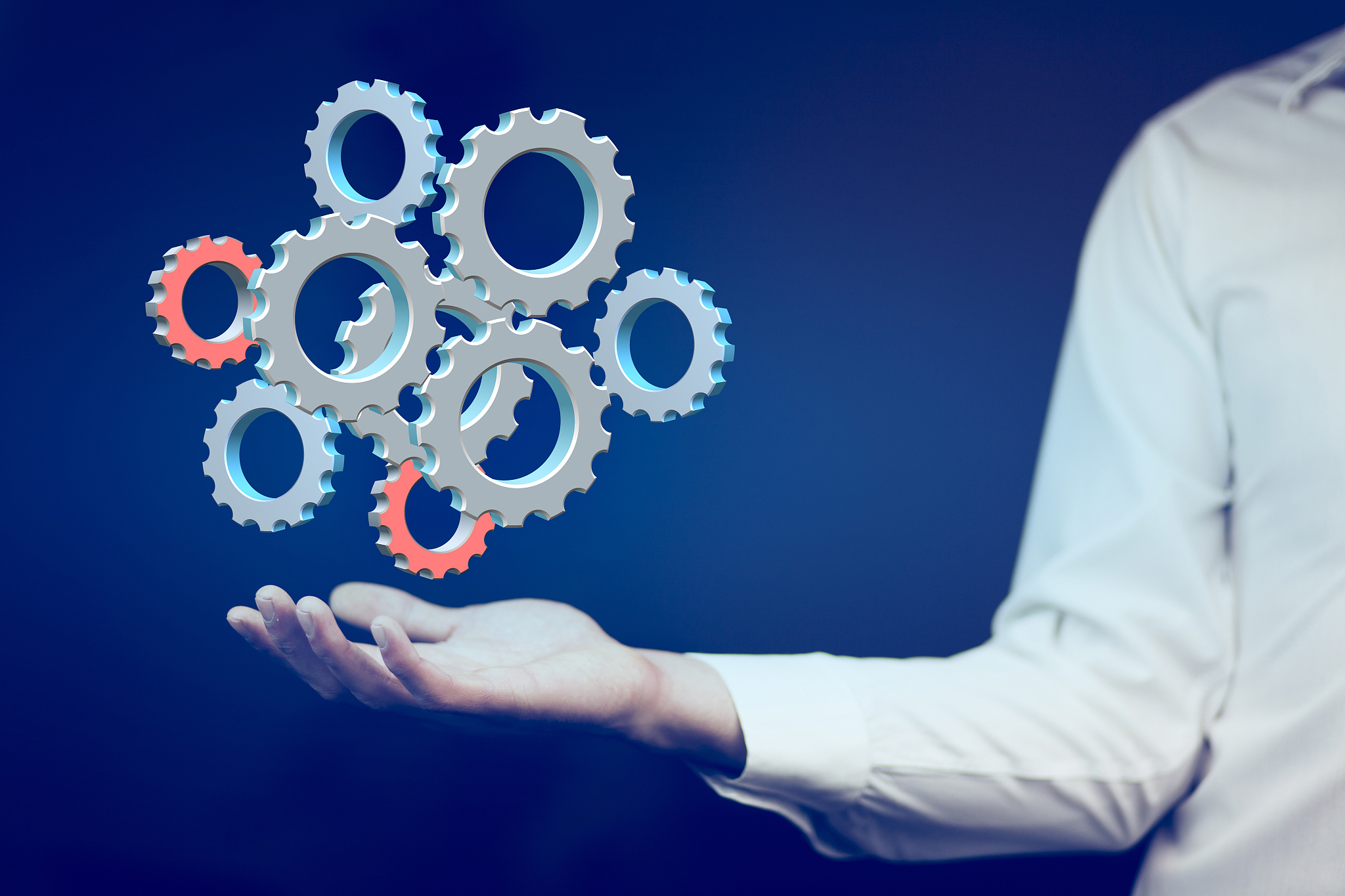close up of businessman holding gears in palms