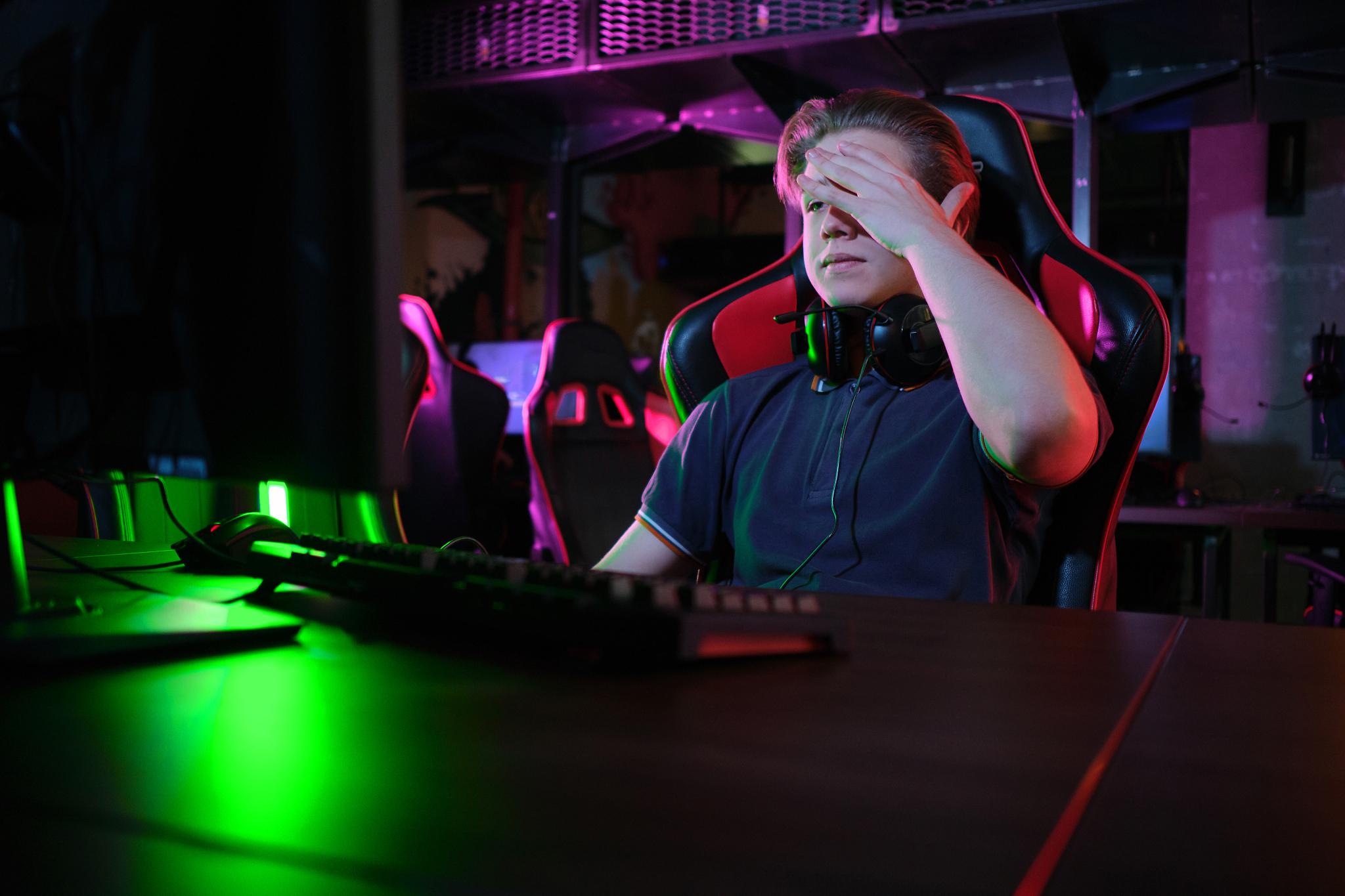 professional young caucasian gamer playing online on his pc. he 